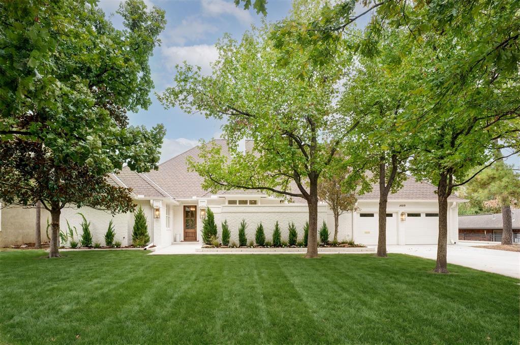 Open House on Thursday Oct. 8, 3–6 PM. Completely remodeled and thoughtfully reimagined by Kirby Home Designs, this Nichols Hills home is filled with beautiful finishes and luxury details, including Visual Comfort lighting, Schumacher wallpaper, Baldwin, Emtek and Top Knobs hardware, Bespoke Zellige backsplash, custom cabinetry with intentionally added storage, cast-stone and marble fireplaces, marble countertops, Taj Mahal and Cristallo quartzite countertops, and all custom tile from Artisan Studio. Set on a .31-acre lot just blocks from Kite Park and Nichols Hills Plaza, the home offers four bedrooms: three bedrooms plus an office on the main level and a fourth bedroom upstairs. The entry makes an immediate statement with Schumacher wallpaper and opens to the formal dining room with custom trim work and a striking two-sided marble fireplace. The oversized living room features custom built-ins with Schumacher grasscloth, Visual Comfort sconces, and a cast-stone fireplace. Designed for entertaining, the custom bar includes marble countertops, antique glass backsplash, ice maker, beverage refrigerator, bar sink, and bar seating. Just off the living room, the private study features double doors, built-ins, and a statement lantern. The kitchen is a showstopper with custom cabinetry, Bespoke Zellige backsplash, Taj Mahal quartzite, panel-ready appliances, custom vent hood, Perrin & Rowe faucet, and ILVE brass-trim range. A coffee bar, pantry, mudroom, and casual dining space add function without sacrificing style. The primary suite offers separate closets and a spacious bath with a soaking tub, oversized shower, and abundant cabinetry. A large laundry room with sink, hanging space, and additional storage is conveniently nearby. Outside, enjoy a private courtyard with custom landscaping, generous front lawn, and large covered back patio. Completely renovated and truly move-in ready-this is one you won’t want to miss. Sellers are licensed agents.