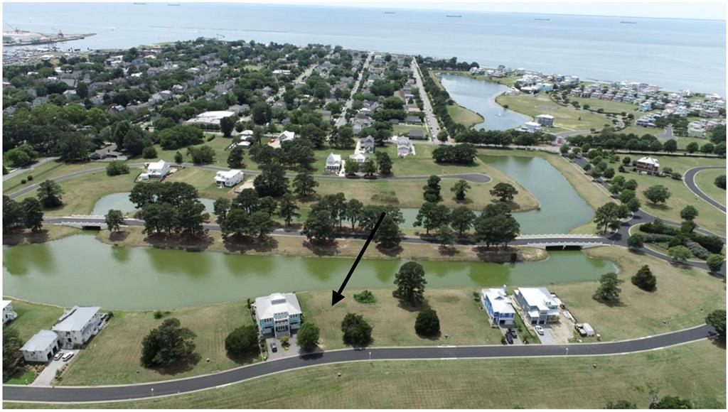 Discover the perfect setting for your dream coastal home in Bay Creek's prestigious gated community of Marina Village East. This beautiful pond-front homesite is surrounded by tranquil water views, creating a peaceful backdrop while showcasing breathtaking Chesapeake Bay sunsets. Ideally located within walking or golf cart distance of the Oyster Farm Seafood Eatery & Marina, C-Pier, Central Park, home to popular summer concerts and community events and the charming shops, restaurants, ice cream parlors, and boutiques along Mason Avenue in historic Cape Charles. Bay Creek offers an exceptional coastal lifestyle with optional membership opportunities that provide access to the renowned golf course and Life Center. Included with the Bay Creek HOA are resort style amenities featuring private pools, a secluded beach, tennis and pickleball courts, and the beloved Coach House Tavern. Whether you're planning a full time residence or a weekend getaway, this waterfront homesite offers the perfect blend of luxury, recreation, and small town charm in one of the Eastern Shore's most sought after communities.
