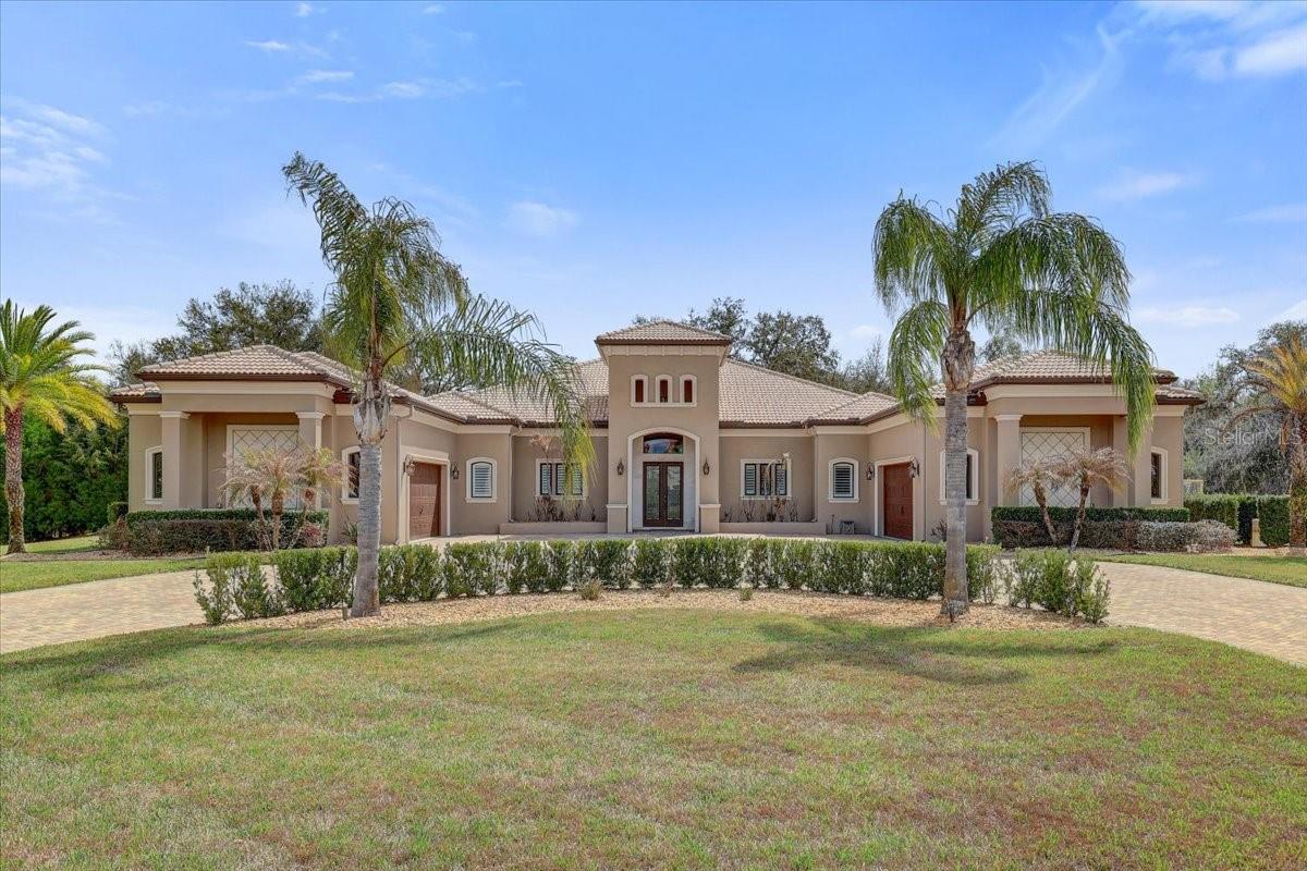 Under contract-accepting backup offers. APPROX. 1.2 ACRES!!!6 BEDROOM 5 FULL BATH!!!, 4 CAR GARAGE!!!, OVERSIZED SCREENED IN BEAUTIFUL POOL AND DECK AREA,!!!! TURF SOCCER TRAINING AREA!!!, BASKETBALL COURT!!!-Welcome to an extraordinary single-story luxury estate offering approximately 5,000 square feet of refined living on a private 1.2-acre homesite in the exclusive gated community of The Sanctuary. Built with solid poured concrete construction and a timeless tile roof, this exceptional residence blends durability, elegance, and resort-style amenities rarely found in one property. From the moment you arrive, the expansive paver driveway and impressive curb appeal set the tone for what awaits inside. The thoughtfully designed floor plan features 6 bedrooms, 5 bathrooms, and a versatile bonus room, all complemented by stunning wood floors and high-end finishes throughout. At the heart of the home is a spectacular chef’s kitchen, outfitted with Wolf and Sub-Zero appliances, dual dishwashers, custom cabinetry, and generous workspace, making it ideal for both everyday living and large-scale entertaining. The oversized laundry room, complete with two washers and two dryers, adds an exceptional level of convenience.-Step outside to your own private resort-style backyard. The massive oversized pool and expansive deck create the ultimate setting for gatherings and celebrations, while the built-in outdoor kitchen makes outdoor entertaining effortless. A panoramic pool cage with stunning Nebula lighting transforms the space into a dramatic evening retreat. For sports and recreation, the property offers a professional-grade turf soccer field with goal and a half-court basketball court with Sport Court surface, both enhanced by stadium lighting for nighttime play. Thoughtfully designed landscape and architectural lighting illuminate the entire property, creating a breathtaking ambiance after sunset.This remarkable estate delivers the perfect combination of luxury, space, and lifestyle, offering an unparalleled opportunity to own a truly unique property designed for entertaining, recreation, and exceptional everyday living.
