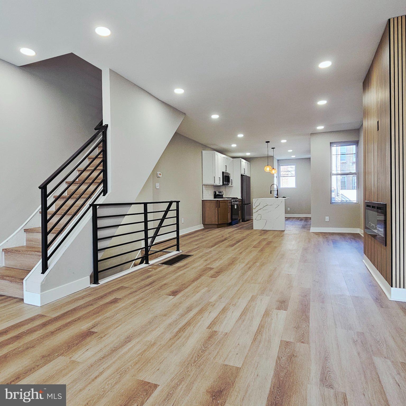 Beautifully renovated from top to bottom, this stunning row home offers modern finishes throughout! Enjoy a welcoming front patio, an open-concept living and dining area with a sleek electric fireplace, beautiful flooring, and a brand-new kitchen featuring a large island. Elegant iron railings add a modern touch. The second floor offers three spacious bedrooms, including a primary suite with a beautiful private bathroom and shower, plus a stylish hallway bathroom. The finished basement includes a laundry area and additional living space. Convenient access from the kitchen leads to the ground-level garage and outdoor area. The home has been extensively updated, including new plumbing, new electrical, new HVAC, new water heater, new windows, new doors, new insulation, and new drywall. Newer roof, approximately 2-3 years old. Conveniently located near shopping, transportation, and everyday amenities. Move right in and enjoy this beautifully updated home!