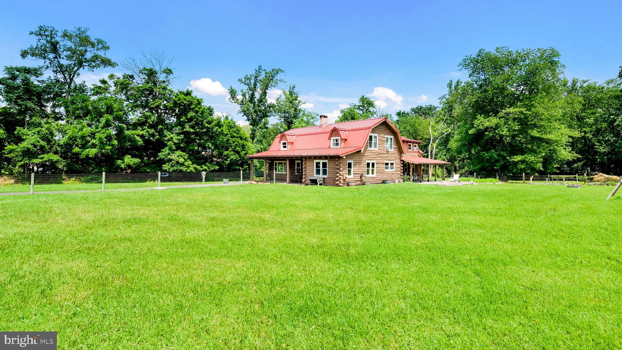 Yes! That is a Log Cabin on 2 acres in Ivyland. Set way back off of Bristol road.  Built in 1989, this rustic home features 4 spacious bedrooms, 2 1/2 baths, full basement, fenced yard and 2 covered porches.  The first floor has a large living area with a pellet stove.  The large Kitchen adjoins the dining area which is great for entertaining.  Off the kitchen there is also access to a Den, Office and play or exercise area. The Den features an additional pellet stove.  A 1/2 bath completes the 1st floor.  Upstairs is the large primary bedroom with a full bath. There is also 3 other bedrooms and an additional full bath. The basement is great for storage and there is a Bilco door.  Other features of this unique home: Newer Oil heater with 3 zones, Newer Metal roof,  200 AMP electric service, Council Rock School District, Andersen Windows, Hardwood floors, Recessed lighting and more!  Just so you know, even though you may feel like you are way out in nature, you are still relatively close to some great places to get provisions....