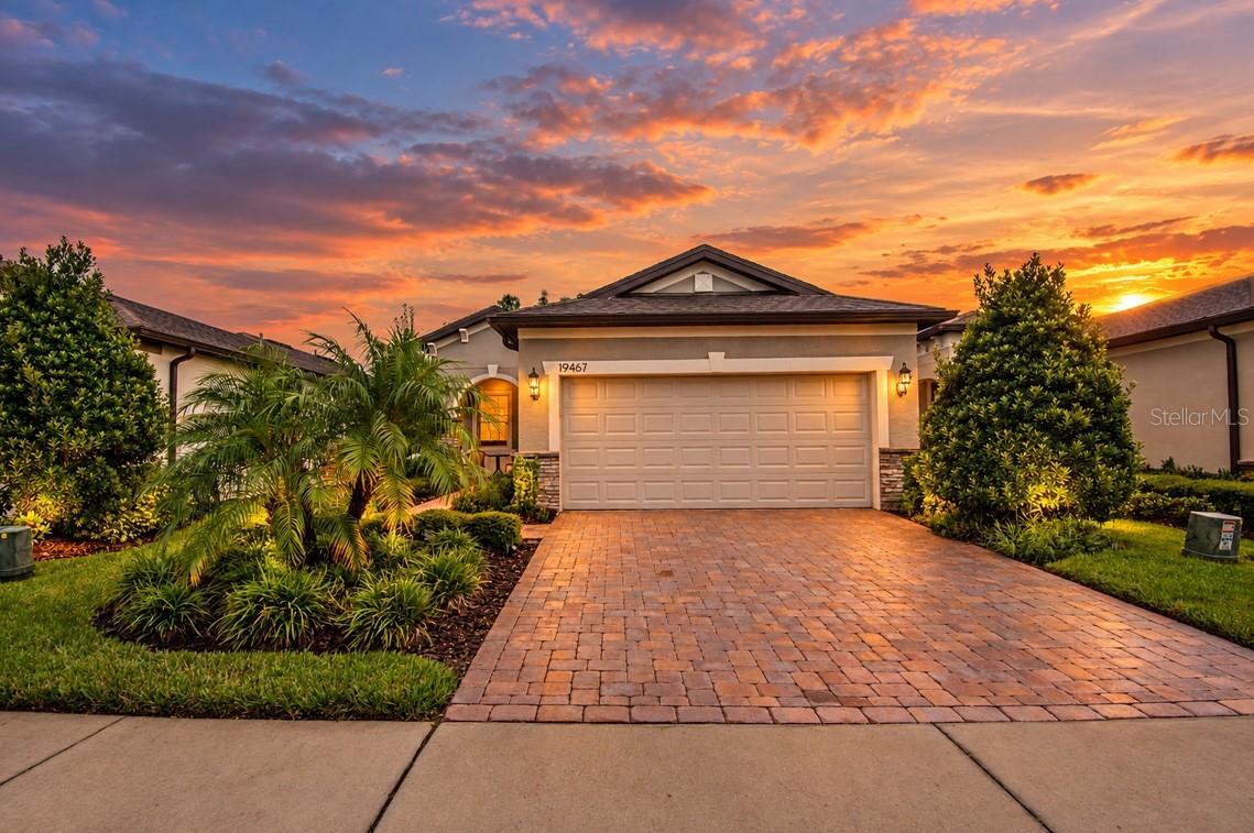 Discover comfortable Florida living in this beautifully upgraded 2-BEDROOM, 2-BATHROOM HOME located in the desirable 55+ COMMUNITY OF DEL WEBB BEXLEY in the heart of Land O’ Lakes, Florida. Thoughtfully designed with elegant finishes, inviting living spaces, and peaceful natural views, this home offers a wonderful blend of comfort, style, and resort-style living.From the moment you enter, the LEADED GLASS FRONT DOOR sets the tone for the home's distinctive character. Inside, CROWN MOLDING elegantly frames the ceilings, while ROUNDED WALL CORNERS and CUSTOM LINEN SHADES add subtle details throughout. The home features LUXURY VINYL PLANK FLOORING THROUGHOUT THE HOME, providing a stylish, durable surface that is easy to maintain, with NO CARPET.The kitchen is designed to be both functional and inviting, highlighted by an impressive 12-FOOT LONG ISLAND that offers plenty of space for meal preparation, casual dining, and entertaining family or friends. A GRANITE KITCHEN SINK adds an upscale finish, while the GAS STOVE is perfect for those who enjoy cooking. For additional convenience and flexibility, a STUB GAS LINE is located on the side of the house, allowing for a potential gas grill or generator connection.The owner's suite provides a relaxing place to unwind, complete with SPECTACULAR VIEWS of the lush surroundings and natural landscape. A SPACIOUS MASTER CLOSET offers ample room for clothing and storage, while the ensuite bathroom features a CHARMING BARN DOOR that brings both character and functionality to the space.Another standout feature is the inviting FLORIDA ROOM, finished with beautiful FRENCH-CUT TRAVERTINE FLOORING and HURRICANE-PROOF WINDOWS. Natural light fills this space, making it an ideal spot for reading, relaxing, or simply enjoying the peaceful scenery. Beyond the home, a CONSERVATION AREA and tranquil pond create a lovely natural backdrop, allowing you to appreciate the beauty of the surrounding landscape.The lifestyle continues throughout Del Webb Bexley, a community known for its impressive 19,000 SQUARE FOOT AMENITY CENTER and wide range of recreational opportunities. Residents can enjoy a RESORT-STYLE POOL, a clubhouse featuring a CAFE FOR SOCIAL GATHERINGS, and a STATE-OF-THE-ART FITNESS CENTER. For sports and friendly competition, the community also offers TENNIS AND PICKLEBALL COURTS, a BOCCE BALL COURT, and a RESISTANCE POOL. There is even a POOL TABLE for additional indoor recreation and socializing.With its carefully selected upgrades, peaceful conservation and pond views, versatile Florida Room, and access to an outstanding collection of amenities, this home offers an appealing opportunity to enjoy a comfortable and active 55+ LIFESTYLE IN LAND O’ LAKES, FLORIDA. Experience all that Del Webb Bexley has to offer in a home designed for relaxation, recreation, and everyday enjoyment.