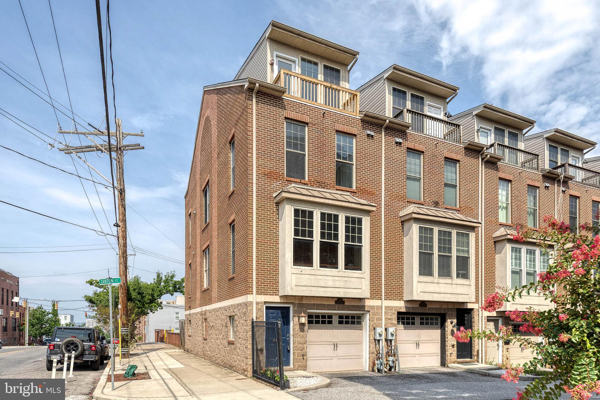 Welcome to this stunning 4-story brick end-of-group townhome in the heart of Canton, offering 4 bedrooms, 4.5 bathrooms and plenty of space for whatever you need! Hardwood flooring through, with open-concept main level connects the living and dining areas to the beautifully appointed kitchen. The kitchen features a large island with counter seats, abundant cabinetry, and a sliding glass door leading to a private balcony.The upper level features the primary with a huge walk in closet and primary bath with double vanity and soaking tub, as well as a second bedroom with an en suite bathroom and ample closet space.  The top level is perfect for entertaining or working from home, featuring a built-in wet bar with beverage refrigerator, and an additional bedroom with private balcony and full bathroom. Step outside to the rooftop deck and enjoy views of the city, an ideal space for relaxing or hosting guests on warm evenings.The entry level offers interior garage access, an additional bedroom room with a full en suite bathroom for added convenience. Located just moments from Canton Waterfront Park, Canton Square, shopping, dining, and major commuter routes, this exceptional home offers spacious, flexible living in one of Baltimore’s most desirable neighborhoods.
