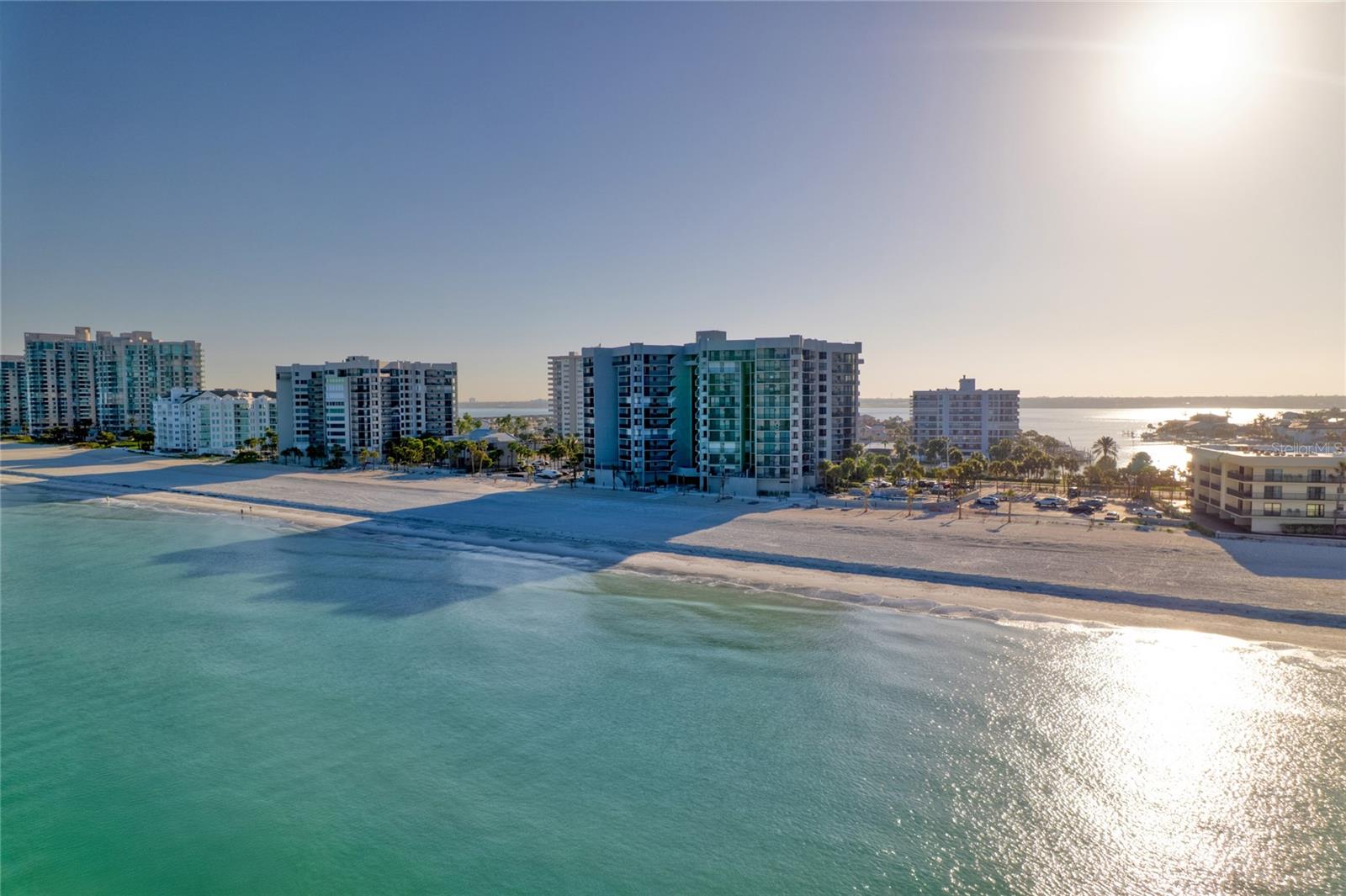 One or more photo(s) has been virtually staged. Water views throughout this 8th floor residence on Sand Key, with direct beach access just an elevator ride away. Opportunities to purchase a residence with these views and elevation in Dan’s Island do not come along often.Wake up to water views and end your day with stunning sunsets from this 8th-floor residence in the highly sought-after Dan’s Island on Sand Key. With 1,610 square feet of living space and expansive balconies, this home offers the coastal lifestyle buyers come to Florida for.From the moment you enter through double doors, you’re welcomed by natural light and immediate water views. The spacious living and dining area opens seamlessly to the main balcony, creating the perfect setting to relax, entertain, and enjoy the breeze off the Intracoastal.The split-bedroom floor plan offers privacy for both owners and guests. The guest suite features its own private balcony, while the primary suite is tucked away with direct balcony access, a large en-suite bath with soaking tub and separate shower, and a custom closet system.The kitchen is centrally located with granite countertops, ample cabinetry, and a new refrigerator (2024), making it both functional and connected to the main living space.Additional features include tile flooring throughout, hurricane-impact sliding doors and windows, in-unit washer and dryer (2021), and an electric fireplace for added comfort and ambiance.Dan’s Island offers resort-style amenities including 24-hour guard-gated security, a beachfront pool and spa, fitness center, indoor basketball and racquetball courts, clubhouse, grilling areas, and direct access to the beautifully maintained Sand Key beach.The monthly condo fee covers cable, internet, water, sewer, trash, building and grounds maintenance, insurance, reserves, and on-site management—providing true lock-and-leave convenience.Located just minutes from Clearwater Beach, dining, shopping, and entertainment, this is a rare opportunity to own a view-oriented residence in one of Sand Key’s most desirable communities.If you’ve been waiting for the right view and elevation—this is it. Schedule your showing today.