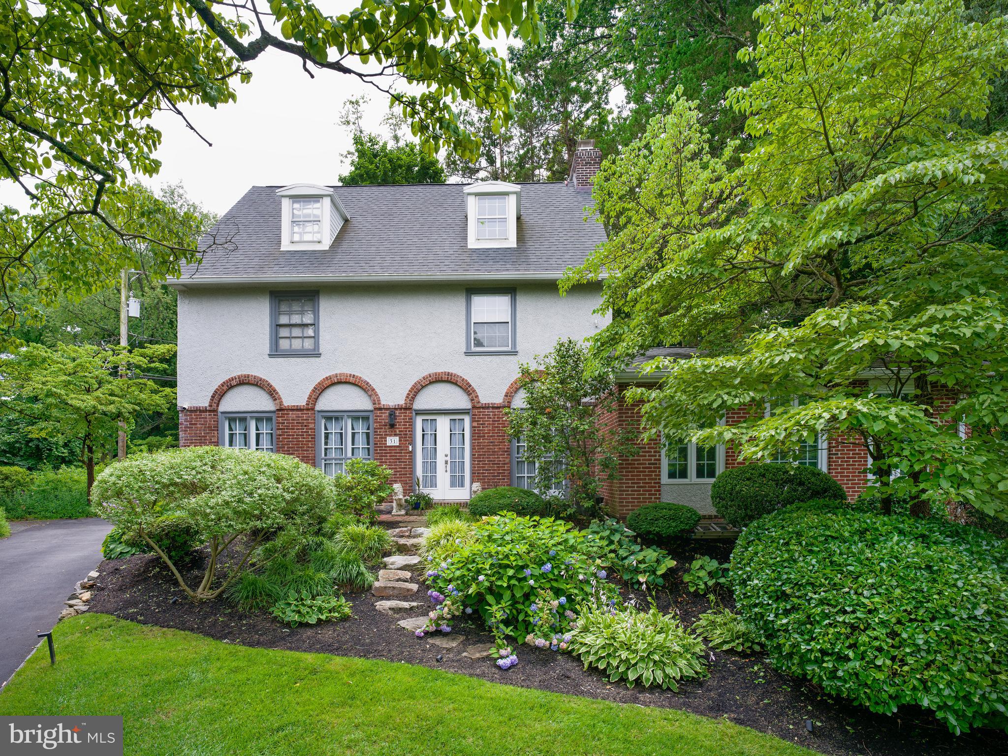 Set on a quiet cul-de-sac behind lush, professionally landscaped gardens in one of Bala Cynwyd's most desirable neighborhoods, this beautifully updated five-bedroom residence seamlessly blends timeless architecture with thoughtfully renovated living spaces and exceptional indoor-outdoor entertaining. Located within the award-winning Lower Merion School District and just moments from the Cynwyd Heritage Trail, regional rail, parks, shopping, dining, and Center City Philadelphia, the home offers the perfect balance of privacy, convenience, and everyday luxury.A charming front entry welcomes you into a gracious center hall that immediately showcases the home's classic layout. Straight ahead, the formal living room is anchored by a handsome wood-burning fireplace and framed by rich hardwood floors, elegant millwork, and oversized windows that fill the space with natural light. To the right, the expansive family room features soaring vaulted ceilings, walls of windows, and direct access to the rear patio, creating a seamless connection between indoor and outdoor living. To the left of the foyer, the formal dining room offers an inviting setting for both everyday meals and special occasions and is conveniently complemented by a nearby powder room. Beyond the dining room, the eat-in kitchen delivers crisp white cabinetry, stainless steel appliances, sleek soap stone counters, abundant workspace, a breakfast area, and a secondary staircase providing convenient access to the upper level.The second floor hosts three bedrooms, including a serene primary suite with a wall of closets and a beautifully updated en-suite marble bath featuring an oversized glass shower with dual shower heads, pebble-stone floor, and rich double-sink vanity. Two additional bedrooms on the third floor share a well-appointed full bathroom with dual shower heads, creating an ideal space for guests, home offices, or flexible living arrangements.The outdoor living spaces are where this home truly distinguishes itself. Designed as a natural extension of the interior, the private backyard is perfectly suited for entertaining and everyday enjoyment. Gather around the impressive outdoor kitchen and bar, and built in professional grade grill with a natural gas hookup, host dinners on the expansive patio, unwind beneath the custom pergola in the luxurious hot tub, watch the game on the outdoor television, or simply relax while children and pets enjoy the beautifully landscaped yard surrounded by mature trees, and customized exterior lighting controlled by an app with hundreds of custom light color options. Despite its incredibly convenient location, the property offers a remarkable sense of privacy and tranquility that's increasingly difficult to find.An unfinished basement offers abundant storage and exciting potential for future finished living space, while the detached one-car garage and backyard shed provide additional parking and storage for daily convenience.Presenting five bedrooms, beautifully updated interiors, outstanding outdoor entertaining spaces, and an exceptional Main Line location, 31 Snowden Road is more than a beautiful home; it's a place where everyday living feels like a retreat.