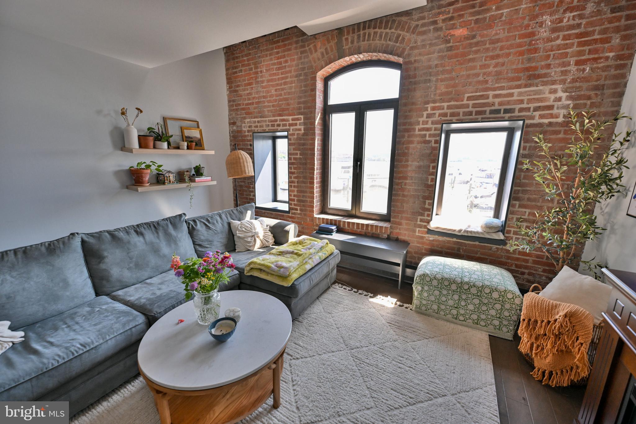 Welcome to Unit #206 at Henderson's Wharf located in the heart of Historic Fells Point! This gorgeous 2-level, 1 bedroom, 1 full bathroom condo with breathtaking waterfront views is a must see. The main level is bathed in natural light and offers an open concept design encompassing the living, dining, and kitchen areas. You'll find granite countertops. stainless steel appliances, exposed brick walls, wood floors, and a breakfast bar. The stairs lead to a spacious primary bedroom with a large walk-in closet, a closet with stackable washer and dryer, and a full bathroom. You have access to common areas and courtyards (both indoor and outdoor), 1 deeded parking space in the secure garage with interior access to the hallway, 24-hour security and concierge service, and a fitness center. Exit the building  onto cobblestone roads leading to walking and jogging paths along the waterfront, local shops and restaurants, vibrant nightlife, nearby grocery stores, and easy access to interstates I83 and I95. The perfect place to call home!