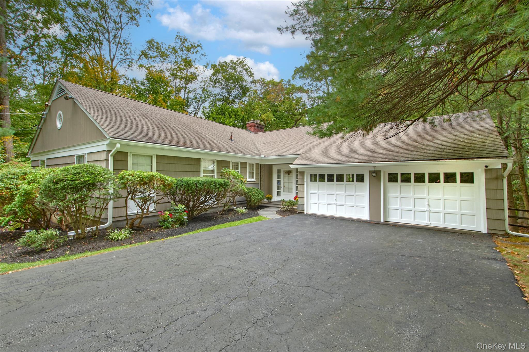 Perfectly positioned on a serene and private 1.72 parcel in the sought-after, coveted Commodore Road neighborhood, this classic ranch-style home offers incredible potential just minutes from Chappaqua village, train, shops, and schools. Surrounded by mature trees, natural rock outcroppings, and a level backyard, this beautifully sited property with a majestic long driveway, is a rare find—offering both privacy and convenience. This meticulously maintained and solidly built home originally owned by its builder, offers an exceptional combination of privacy, natural beauty, and convenience to every amenity. This nearly 2,000 sq ft home with additional living area not included in the sq ft, provides the perfect structure for a forever home and your personal vision. The spacious first floor features a wide welcoming entry hall, leading to an oversized living room with a mantled fireplace and walls of windows bathing the room in natural light framing unforgettable woodland views. The formal dining room adjoins the kitchen and an enclosed 500 sq ft (not included in the home's sq ft) three season glass-enclosed screened porch with high soaring ceilings which brings the outdoors in and fills the home with natural light. The spacious deck is accessible from both the enclosed porch and kitchen which provides effortless modern indoor outdoor entertaining amid natural beauty. Gleaming hardwood floors found throughout the home, further enhance the home's space. Two steps up to the charming bedroom mezzanine which features three large bedrooms, including a primary suite with en-suite bath and two additional oversized bedrooms share a hall bath, offering flexibility for family, guests, or home office space. The lower level includes a large unfinished basement with a wonderful walk-out room (370 sq ft) with a wood burning fireplace, large picture windows and door out—ideal for a media room, playroom, gym, or home office. The utility room with a NEW Burnham boiler and hot water heater also has ample room for a modern laundry room. The basement also has a third large storage room with above-ground oil tanks and plenty of room for a workshop. The house enjoys radiant ceiling heat via copper piping. There is a walk-up attic in the home which offers more storage space and additional expansion opportunities. 2 car garage with two entry doors and separate attic storage. This home is an exceptional opportunity with endless possibilities in a prime Chappaqua location—not to be missed!!