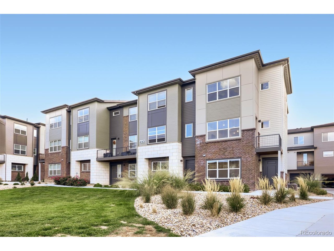 Enjoy big-city convenience from a quiet neighborhood in this well-maintained four-bedroom, three-and-a-half-bath townhome built in 2023 in Grand Vue at Interlocken. FlatIron Crossing's shopping, dining and entertainment are minutes away, as is the Interlocken business park. When it's time to unwind, miles of trails for walking, biking and other outdoor activities are close by.The two-car garage has room for a larger vehicle and extra storage space at the back. A bedroom sits off the entry next to a full bathroom with quartz countertops, a tub, and tile in excellent condition, making the main level a good fit for guests or a home office.Head up to the second level and the home opens into its main living space. The kitchen offers quartz countertops, Shaker-style cabinetry, and a stainless steel appliance package with a gas range and built-in microwave. An island with seating and a dining area make it easy to cook and gather, and a small deck off the kitchen gives you a spot for morning coffee outdoors. Beyond the kitchen, the living room is large enough for oversized furniture, and a side nook works well as a dedicated work-from-home space. A powder room on this level means no trips up and down the stairs. Laminate flooring runs throughout.Newer carpet leads up to the third level, where you'll find three more bedrooms, each with a ceiling fan and two with walk-in closets. The primary bedroom has its own bathroom with quartz countertops, a walk-in shower, and a separate toilet room. A second full bathroom with quartz countertops serves the other two bedrooms, and a full-size front-load stackable washer and dryer round out the upper floor.Outside your door, amenities include a playground, a grilling area, and an outdoor kitchen with a built-in pizza oven, plus a fire pit, built-in cornhole, and picnic tables. The professionally landscaped grounds are well maintained, guest parking is plentiful, and pet waste stations make the community pet friendly.