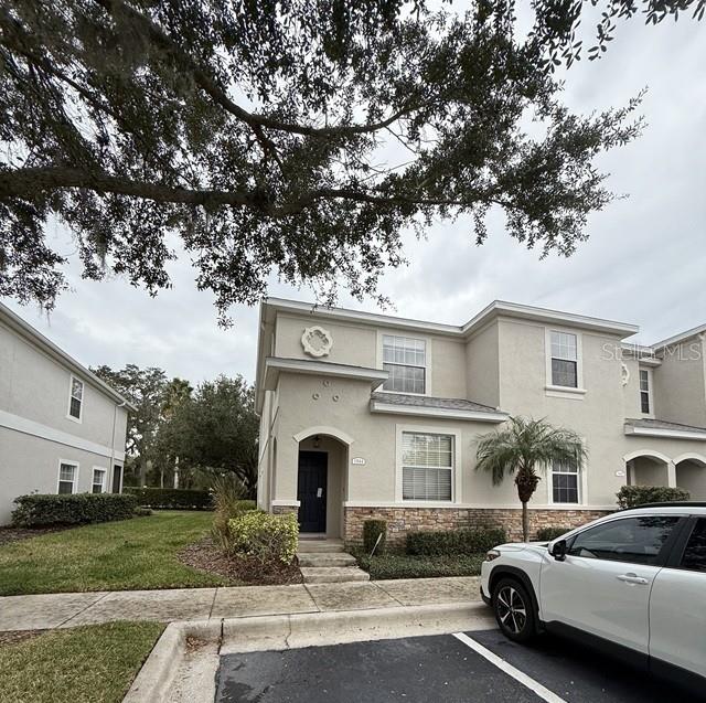 Welcome to this well-kept 3 bedroom, 3 bathroom townhome in the gated Walden Woods community, offering convenience, value, and a low-maintenance lifestyle. Built in 2007, this home features 1,572 sq ft, a functional two-story layout, and a spacious open living area on the ground floor. Recent improvements include a new roof, A/C, and a screened lanai, providing peace of mind and comfortable living. The floor plan includes a downstairs bedroom with an adjacent full bath—ideal for guests or a home office—plus two upstairs en-suites, each with walk-in closets and private bathrooms.