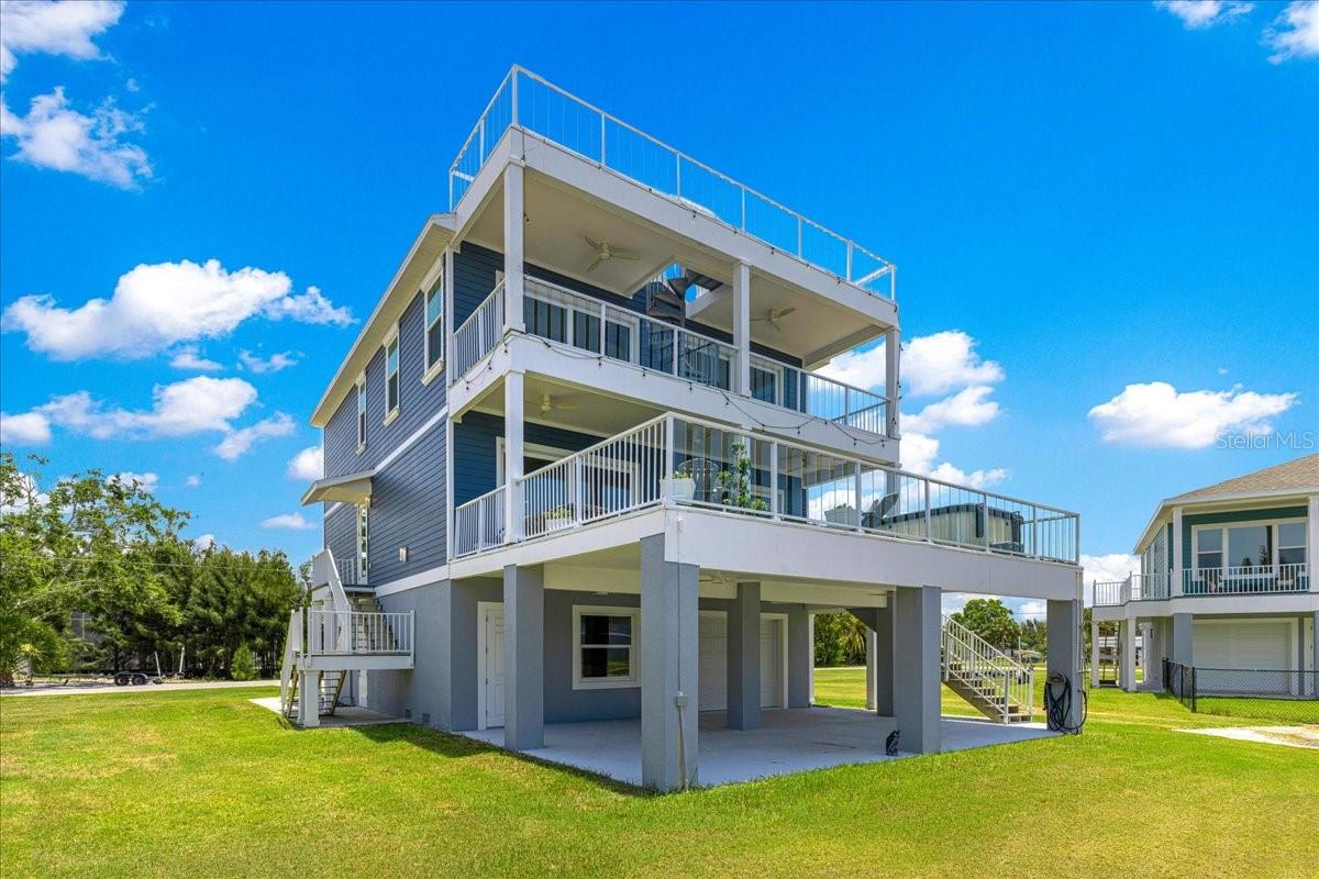 Experience luxury waterfront living in this exceptional custom-built coastal residence located in the desirable Driftwood Isles community of Hudson. Built in 2022 and thoughtfully designed for both everyday living and entertaining, this stunning 4-bedroom, 3-bath home offers approximately 2,400 square feet of beautifully appointed living space, a private elevator servicing every level, expansive outdoor living areas, and direct Gulf access from your own backyard.Step inside to discover an open-concept floor plan highlighted by soaring ceilings, luxury finishes, abundant natural light, and a spectacular chef's kitchen featuring an oversized quartz island, custom cabinetry extending to the ceiling, stainless steel appliances, designer lighting, abundant storage, and a spacious walk-in pantry. The kitchen flows effortlessly into the living and dining areas, creating the perfect space for hosting family and friends while enjoying beautiful water views.The spacious primary suite offers a peaceful retreat complete with a private waterfront balcony, generous walk-in closet, and an elegant spa-inspired ensuite bath featuring dual vanities and a large walk-in shower. Three additional bedrooms provide ample space for family, guests, or a home office.Designed to embrace the Florida lifestyle, this home offers multiple outdoor living spaces including a large, covered balcony overlooking the canal, an expansive rooftop deck with panoramic views, and a spacious covered ground-level patio perfect for entertaining after a day on the water.Boaters will appreciate the direct canal frontage with quick access to the Gulf of America, making it easy to enjoy fishing, island hopping, sunset cruises, and endless waterfront adventures. The oversized garage provides exceptional space for multiple vehicles, golf carts, kayaks, fishing gear, and all your waterfront toys, while the elevator offers convenient access from the garage to every floor.Ideally located just minutes from waterfront restaurants, marinas, shopping, medical facilities, beaches, and the Suncoast Parkway, this home provides an easy commute to Tampa International Airport and downtown Tampa while allowing you to enjoy the relaxed lifestyle of Florida's Nature Coast.Whether you're searching for a full-time residence, luxury vacation home, or waterfront retreat, this exceptional Driftwood Isles property delivers modern construction, quality craftsmanship, and the ultimate coastal lifestyle.This is Florida waterfront living at its finest—where every day feels like a vacation.