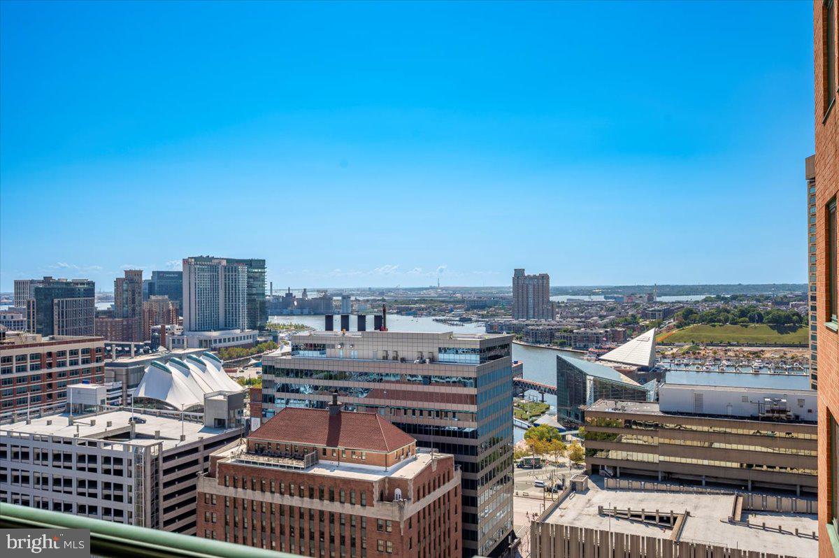 Step into this light-filled and spacious two-bedroom, two-bath condo at 414 Water Street, where floor-to-ceiling windows and a private balcony showcase sweeping views of the Inner Harbor.Designed with comfort and convenience in mind, the open layout offers great flow and thoughtful separation, with each bedroom and bathroom tucked on opposite sides of the home for added privacy. The living area stands out with hardwood floors set on the diagonal, a warm gas fireplace, and a cozy dining space. The upgraded kitchen is sure to impress, featuring granite countertops, an extended breakfast bar, and sleek stainless steel appliances—perfect for both everyday living and entertaining.Each bedroom is generously sized, easily accommodating larger furnishings, and comes complete with a walk-in closet for exceptional storage.Residents of 414 Water Street enjoy resort-style amenities, including: Outdoor swimming pool, Fully equipped fitness center, Community and business rooms, 24-hour front desk and secure building entryAll of this is set in a prime location—just steps from the Inner Harbor, with dining, shopping, entertainment, and the downtown business district right outside your door.
