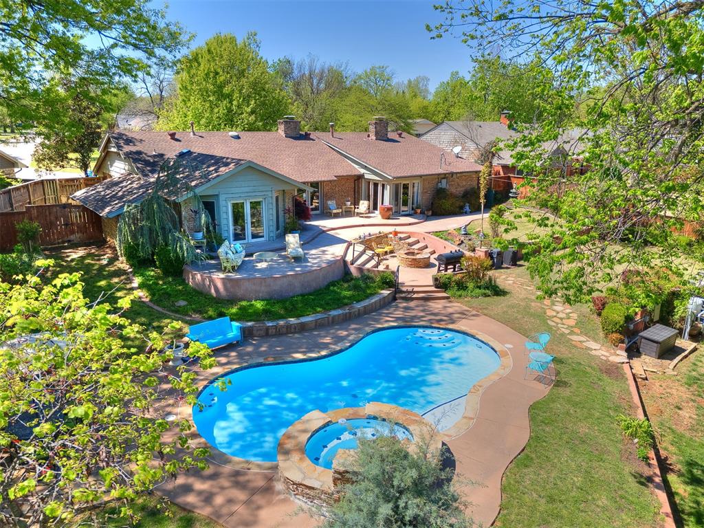 Mid-century modern beauty for those seeking something truly unique—far from cookie-cutter. This 3-bedroom, 2-bath home sits on over half an acre in the heart of Belle Isle and offers a rare blend of character, privacy, and outdoor living. The backyard is an entertainer’s dream, featuring a pool, hot tub, fire pit, terraced patio, and mature trees, with a lower terraced area ideal for gardening or additional outdoor use.Inside, you’ll find stained concrete and wood flooring throughout, along with three original stacked stone fireplaces, including a striking double-sided fireplace between the kitchen and living area. The kitchen is full of character with a copper backsplash, copper vent hood, Wolf gas range with double ovens, eat-in dining space, and a wine bar cubby.Large east-facing picture windows bring in natural light and overlook the pool and expansive backyard. The primary suite features a cathedral ceiling and a luxurious en suite bath with French marble, Absolute Black granite, and an 11-head shower. The secondary bath is finished with Moroccan white porcelain.Additional upgrades include a custom copper garage door with lift (2020, ~$11K), tankless water heater (2019), Pentair pool wireless control system (2020), new main sewer line (2020), updated electrical panel (2017), overhead water lines (2016), HVAC (2016)