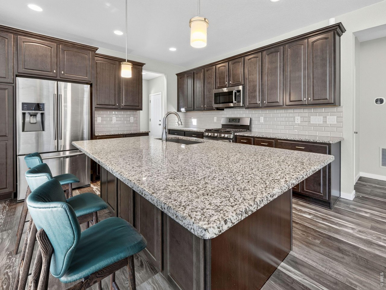 Welcome to this move-in-ready home in Colliers Hill, one of Erie's most popular communities, offering 4 bedrooms, 4 bathrooms, flexible living spaces, and west-facing Front Range views.The main level features an open-concept layout connecting the living room, dining area, and kitchen. A gas fireplace anchors the living room, while the kitchen offers granite countertops, stainless steel appliances, a gas range, ample cabinetry, and a large island with seating. Sliding glass doors open to the private backyard patio. A main-level office with a dedicated bathroom provides flexibility as a non-conforming fourth bedroom, guest space, or home office.Upstairs, a spacious loft adds additional living space alongside a conveniently located laundry room. The primary suite features a walk-in closet and private bath with an oversized shower. Two additional bedrooms share a Jack-and-Jill bathroom.The fully finished basement provides even more room to spread out, complete with a wet bar, dedicated bathroom, and flexible space for entertaining, recreation, a home gym, or media room. Recent updates include fresh interior paint throughout, refreshed front exterior paint, and new sod in the backyard.Colliers Hill offers resort-style amenities with two recreation centers, seasonal pools, fitness facilities, neighborhood parks, 400+ acres of open space, and approximately 15 miles of scenic walking and biking trails. Located above historic Old Town Erie, the community offers convenient access to shopping, dining, recreation, Boulder, and Denver, all within the St. Vrain Valley School District. Combining mountain views, functional living spaces, and exceptional community amenities, this home is ready to enjoy.