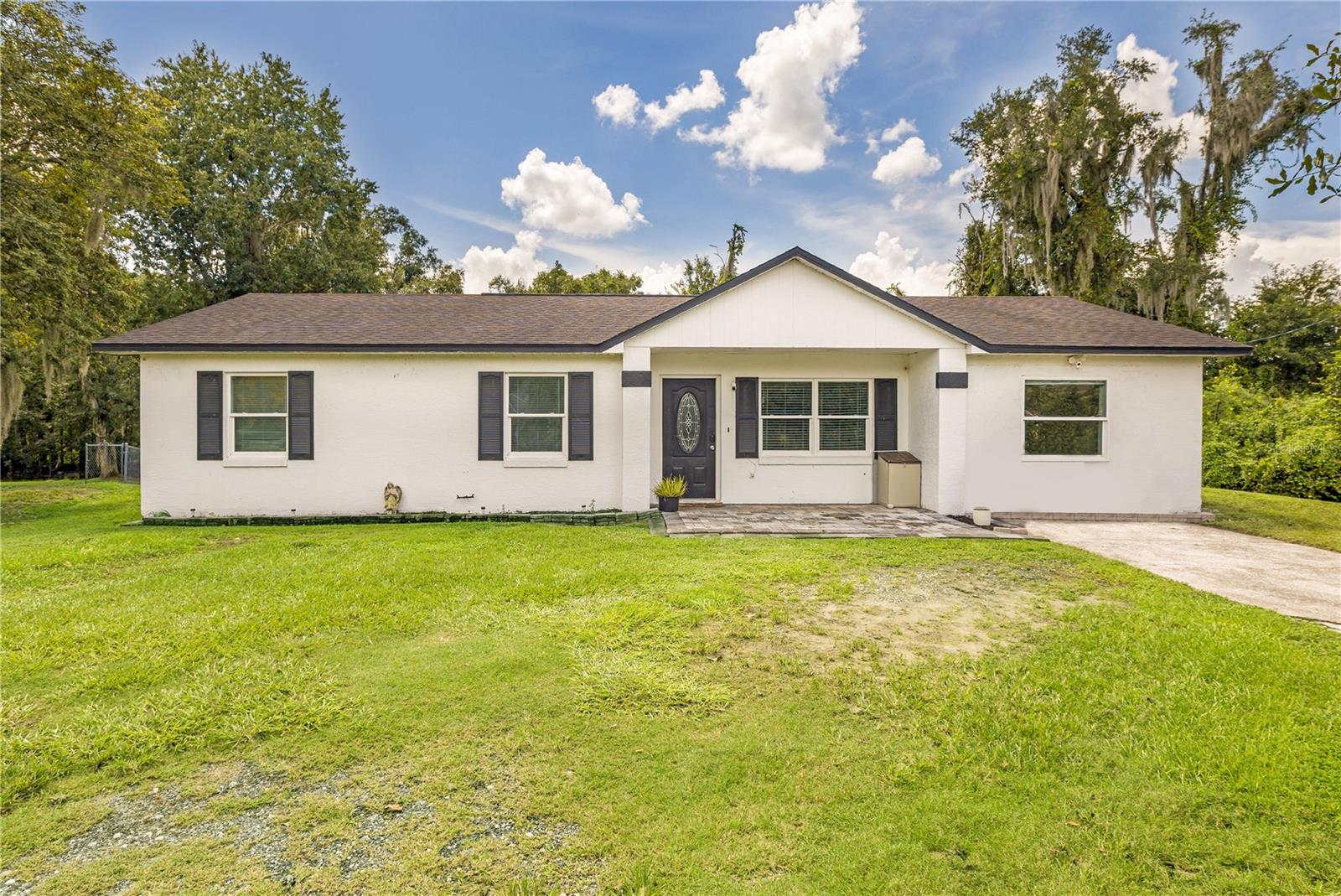 Welcome to this move-in-ready 4/2, North Lakeland home offering a bright interior, flexible living space, and a spacious fenced backyard! The main home features 3 bedrooms and 1 bathroom, with the former garage being converted into additional living space now serving as a spacious primary suite with a private bathroom, creating a great option for a bedroom, guest area, home office, or bonus room. An indoor laundry room adds even more convenience. an open living and dining area, updated flooring, recessed lighting, and a beautifully updated kitchen with ample cabinet and counter space. Step outside to enjoy the large fully fenced backyard, patio area, and plenty of room for entertaining, pets, gardening, or outdoor activities. The home also benefits from several major improvements, including newer windows installed 3 years ago, new roof 2021, new HVAC installed 3 months ago with a 10 year warranty, new water heater installed 6 months ago, and a new drain field installed 6 years ago. Conveniently located in North Lakeland with easy access to shopping, dining, schools, US-98, and I-4. Public records reflect a 3-bedroom, 1-bath home. The garage conversion which adds an additional bedroom now serving as the master suite and master bathroom, were completed with the sellers full intention of remaining at this property indefinitely. This additional space is not included in the public-record bedroom, bathroom, or living-area totals. Buyer and buyer's agent should independently verify square footage and room dimensions.