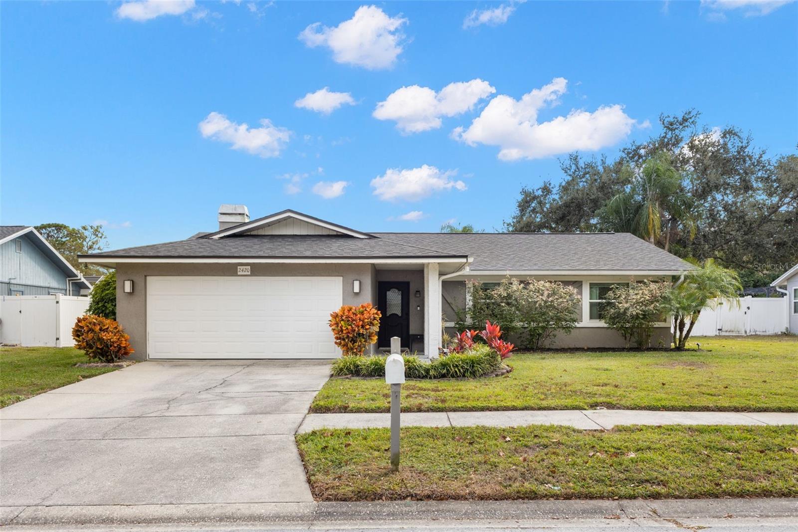 Welcome home to 2420 Osprey Ave, Palm Harbor, FL 34683. Totally updated and move-in ready 3-bedroom, 2-bath pool home with a 2-car garage located in the heart of Palm Harbor, one of Pinellas County’s most desirable communities. This beautifully updated single-family home offers 1,519 square feet of living space and combines modern upgrades, functional design, and Florida lifestyle living. The open great room floor plan features a wood-burning fireplace, vaulted ceiling, tile flooring throughout, and abundant natural light, creating a warm and inviting atmosphere ideal for everyday living and entertaining. The updated kitchen was designed for both style and function with a large island and bar seating, quartz countertops, floating shelves, stainless steel appliances, white shaker cabinets, backsplash, gas range, pendant lighting, excellent storage and room for table and chairs. French doors open directly to the screened pool area, enhancing the home’s seamless indoor-outdoor flow. The primary suite offers a private retreat with sliding glass doors to the pool, a spacious walk-in closet with built-ins, and an updated en-suite bathroom featuring a large walk-in shower with designer finishes for a spa like feel. Two additional bedrooms and a second full bathroom provide flexibility for guests, family, or a home office. Outdoor living is a standout feature, showcasing a fully fenced backyard, side gate, and a screened-in pool enclosure with paver decking and a covered sitting area, perfect for enjoying Florida weather year-round. The pool features a newer marcite finish and offers convenient access to a full bathroom from the pool area. Major upgrades include a newer roof approximately one year old, impact-rated doors and windows, propane service supplying a tankless hot water heater, and a propane-powered generator, providing added peace of mind and reliability during power outages. Located in a non flood zone. Handicap-accessible features and generous storage further enhance functionality. Ideally located minutes from the Pinellas Trail for running, cycling, or just enjoying a stroll to enjoy the views. Close to downtown Palm Harbor, the famous Innisbrook Golf Course, Dunedin, with easy access to parks, marinas, shopping, dining, top-rated schools, Gulf beaches like the award winning Clearwater Beach and Honeymoon Island. Convenient to US 19. Tampa International Airport and Countryside mall.This Palm Harbor pool home offers comfort, preparedness, and an unbeatable location. Call today for  your private showing.