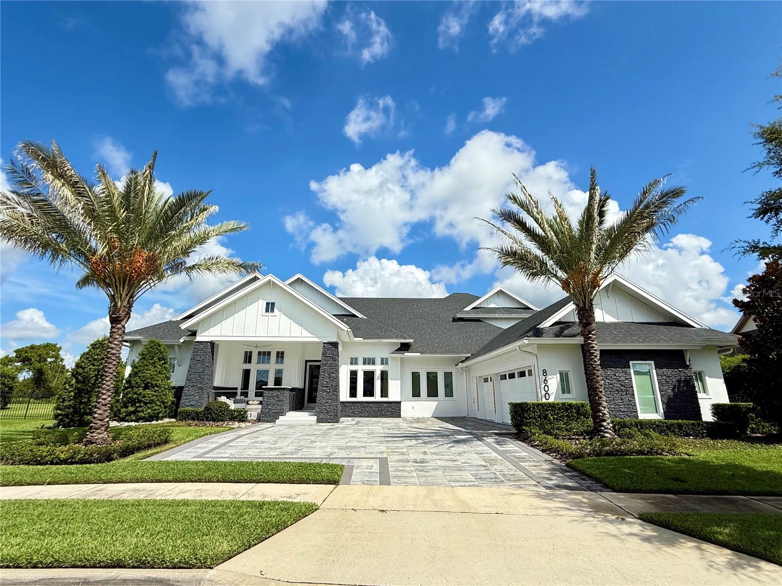 Experience Luxury Living at Its Finest.
This warm, contemporary residence blends modern-transitional style with the highest level of finishes throughout. Offering approximately 5,718 sq. ft. of living space and nearly 7,594 sq. ft. under roof, every detail of this home is crafted to deliver elegance, functionality, and lifestyle excellence.

Featuring five spacious ensuite bedrooms plus an additional full bathroom, the layout is both versatile and inviting. On the main level, you'll find four bedrooms, including the luxurious primary suite a serene retreat with two oversized walk-in closets and a spa style bathroom adorned with exquisite finishes. Additional main-level spaces include formal living and dining rooms, an open-concept kitchen-family room-eating area, a Florida room, a spacious laundry room, a dedicated home office, and a three-car garage with ample storage. Upstairs offers one more bedroom and a versatile multi-purpose room, all set on a .71-acre lot.

At the heart of the home, the gourmet kitchen showcases frameless contemporary cabinetry with automatic lighting, a generous center prep island, three built-in pantry cabinets and premium Wolf and Sub-Zero appliances. The kitchen flows seamlessly into the spacious great room and Florida room, creating the perfect indoor-outdoor living experience.

Step outside to your private outdoor oasis, where beautifully landscaped grounds frame serene conservation views. Enjoy a sparkling pool, relaxing spa, summer kitchen with Bull premium appliances, tranquil yard, expansive covered living space, a fireplace and a basketball court. With plenty of outdoor seating areas, this space is designed for year-round entertaining.

This exceptional home combines sophisticated design, luxurious finishes and an unbeatable layout perfect for both everyday living and memorable gatherings.