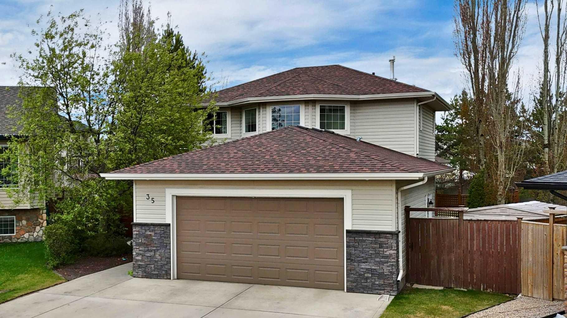 1/3 ACRE PIE LOT | COVERED DECK | OVERSIZED 24 x 30 HEATED GARAGE | RV PARKING ~ This kind of yard and garage space is RARE. Situated on an enormous 14,357 sq ft pie-shaped lot (1/3 acre), this property offers a county-like setting just minutes from schools, shopping, transit, and the Collicutt Centre. Mature landscaping and a forest of trees create a private backyard with RV PARKING and potential for a future shop. The sunny southeast-facing yard also features a COVERED DECK with built-in speakers and expansive stone patio. ~ Inside features a whole-home AUDIO SYSTEM and an open concept layout centered around a gas FIREPLACE. The main floor flows seamlessly between the kitchen, dining, and living areas. The kitchen includes modern stainless appliances with a newer stove (2025), while the main floor office, laundry, and 2-piece bathroom add everyday practicality. ~ Upstairs offers 3 bedrooms including a spacious primary suite with walk-in closet and 3-piece ensuite, plus a full bathroom for the additional bedrooms. ~ The fully finished basement features newer paint and carpet (2025), a large flex space, oversized bedroom, and another full bathroom. ~ Additional features include AIR CONDITIONING, 2 newer hot water tanks (2024), seasonal power receptacles along the fence line, and 50-year shingles (2018). ~ The oversized 24 x 30 heated garage includes in-floor heat, sink basin, work benches, and two man doors — ideal for vehicles, storage, hobbies, or workshop space.