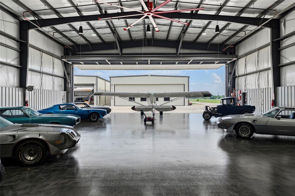 Hangar 73, new-construction toybox hangar for sale. Plenty of room for your car collection, boat, motorcoach, RV, trailer and airplanes. This 60' x 60' hangar boasts quality steel construction, a 54' x 18' hydraulic hangar door, windows, full bathroom, laundry area with hookups, and a kitechette area with AC & heat. Hangar 73 construction should be completed within 60-days. Seller is builder.  Builder has three hangars to choose from. Photos include Hangar 73 and other finished hangars at the airport. Owners can add living quarters, office and conference rooms, workshops and more.  Hangar use restrictions include: No public-facing commercial business, no warehouse use, no flight schools. Aero Country is a private airport, with public use runway.  Fee Simple: You own the land and the hangar.  (This is NOT a ground lease.) Aero Country East is gated, includes a pool and cabana for Owners & guests. Underground utilities, taxiway access and great neighbors.  Conveniently located in North Texas, between Frisco & Prosper, near the PGA Headquarters, in McKinney, Texas. Schedule a showing to view Hangar 73 and the fantastic aviation community of Aero Country East.