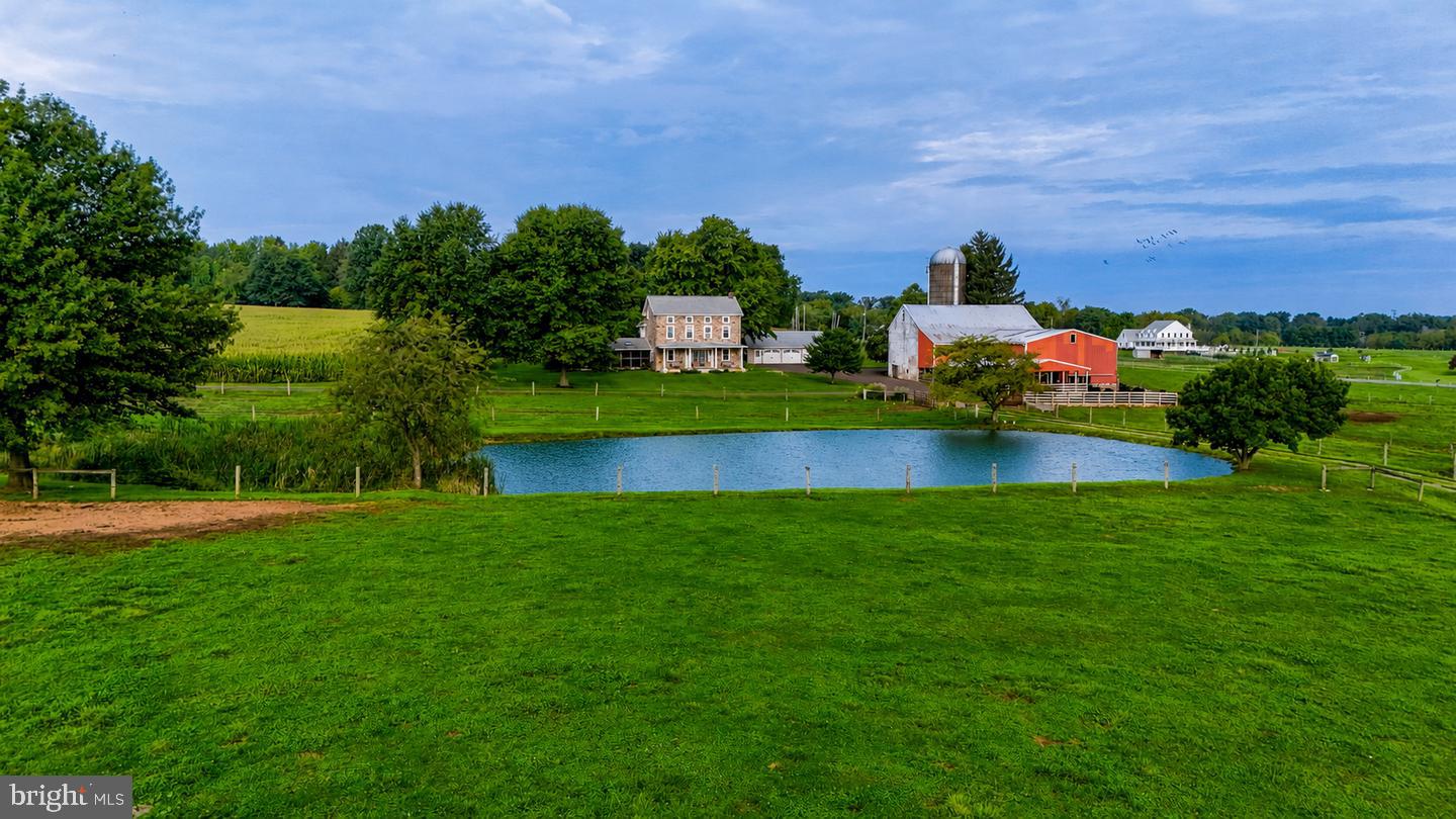 Welcome to 68 Seven Stars, a once in a lifetime opportunity to own a 58 acre rural estate in the heart of East Vincent Township. This property has it all, including an updated stone residence, beautiful bank barn, lush fields, and views overlooking the private pond. The dwelling has been thoughtfully updated throughout the years with custom kitchen, open dining, living room with fireplace, and charming wood floors throughout. The screened-in slate patio is the perfect place to relax, and the front covered porch offers views over the pond and rich farmland valley. The upper-levels include a bedroom suite with bath and walk-in closet, 3 additional bedrooms (1 semi-private), and an additional full bath. The grounds offer prime farmland with 50+ tillable acres and established fenced pasture. The bank barn is used for cattle and could easily be transformed to horse stalls, with the upper level having potential for storage or private event hosting! This farm was recently subdivided and includes 58 acres (see plan in documents). Farm is preserved with Chester County, and the existing building envelope is excluded for added flexibility. Adjoining land is also preserved, protecting the setting and views for generations to come! Within 30 minutes of King of Prussia and Malvern.