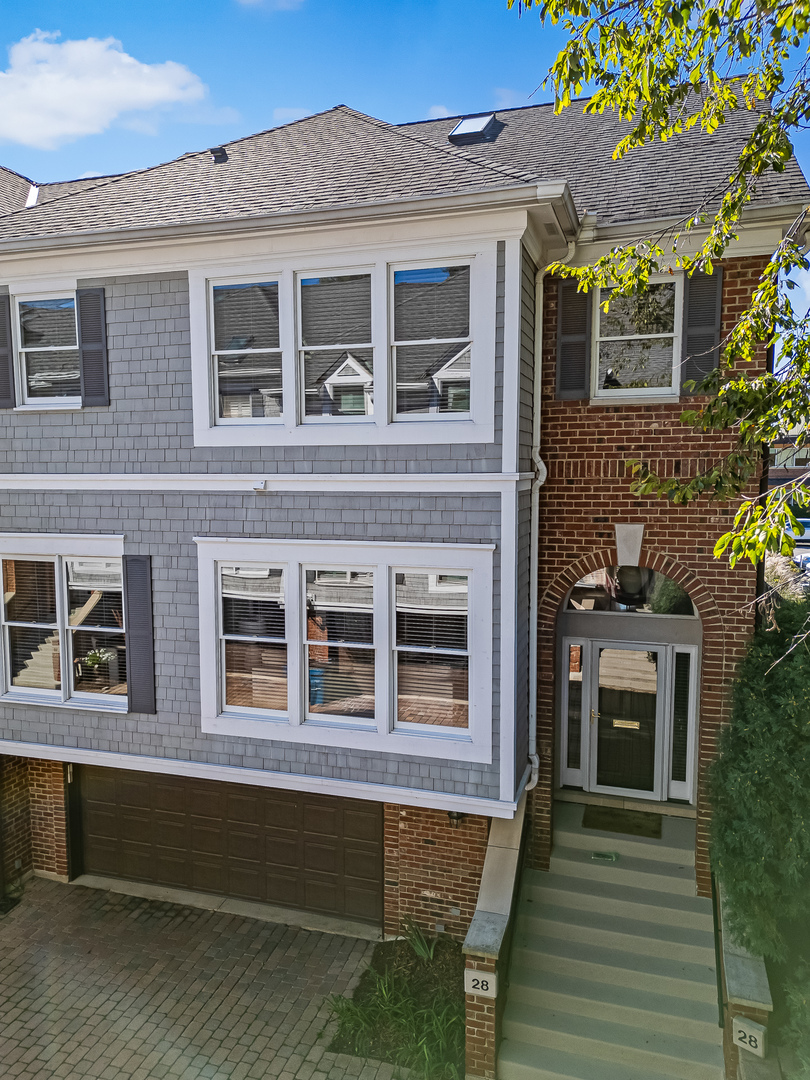 Rare offering in the Courtyard Of Hinsdale. This is the only townhouse community located in-town Hinsdale. It's a true center-of-town lifestyle where all that Hinsdale has to offer is easily walkable. It's an exceptionally bright end unit with a south-facing kitchen for additional light. The Poggenpohl-designed kitchen-featuring SubZero and Wolf appliance-is a showstopper. Upstairs, a serene owners' suite offers two walk-in closets and a spa-inspired bath featuring a zero-threshold shower, heated floors, and Porcelanosa fixtures. The second bathroom continues the fresh aesthetic with a natural wood countertop and vessel sink. A fully fitted laundry room is also on the second floor. A finished lower level complete with its own bathroom adds versatile space for recreation, gym, or an additional bedroom. Completing the package is a rare two-car attached garage. If you're seeking style, convenience, and central Hinsdale walkability, this special property is ready to welcome your next chapter. Quick close possible.