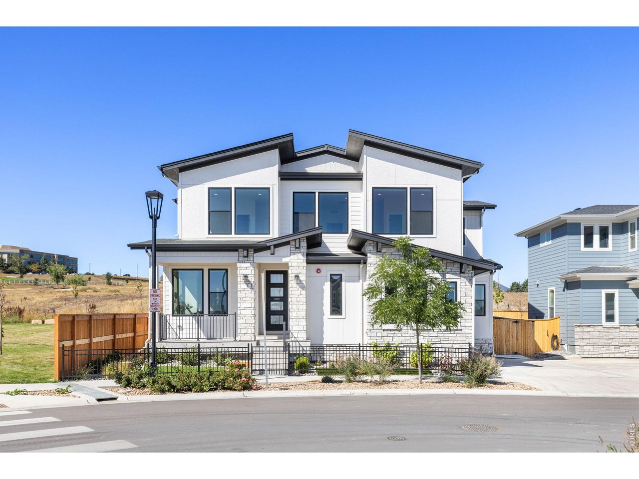 Set along the edge of Downtown Superior with an extensive trail system just outside the front door, this thoughtfully designed home pairs sophisticated style with an exceptional collection of custom finishes and owner upgrades throughout. The main level centers around a spacious kitchen featuring custom cabinetry, Taj Mahal quartzite countertops, an impressive island, a built-in Miele coffee machine, two dishwashers, and premium Wolf, Miele, and Sub-Zero appliances. Generous, light-filled living and dining areas extend outdoors to a covered patio with a built-in outdoor kitchen, ceiling fans, and sunshades, all overlooking a beautifully landscaped, private, fenced-in backyard. A well-organized mudroom off the oversized 2-car garage provides a convenient everyday entry, while a main-floor bedroom/office features a custom king-sized Murphy bed frame with built-in cabinetry and an adjacent 3/4 bath, offering an ideal setup for guests or working from home. Upstairs, the expansive primary suite with western views is a true retreat, showcasing a fireplace, custom beams and lighting, a spa-inspired bathroom, and an impressive custom walk-in closet with direct access to the laundry room. Two additional bedrooms with custom closets and a central family room loft with built-in shelving and a cushioned bench complete the upper level. The finished basement adds a recreation room, kitchen with custom cabinetry and upgraded Bosch, Fisher & Paykel appliances, a 5th bedroom, 3/4 bath, and a storage area with washer/dryer hookups. Custom lighting, Hunter Douglas shades, and thoughtfully designed cabinetry and closet systems further elevate the home throughout. Enjoy easy access to the Marshall Trail system, neighborhood parks, Downtown Superior, Whole Foods, Costco, Target, and the new King Soopers Marketplace. An exceptional homesite with community green space next door, refined design throughout, and convenient access to Boulder and Denver via Hwy 36.