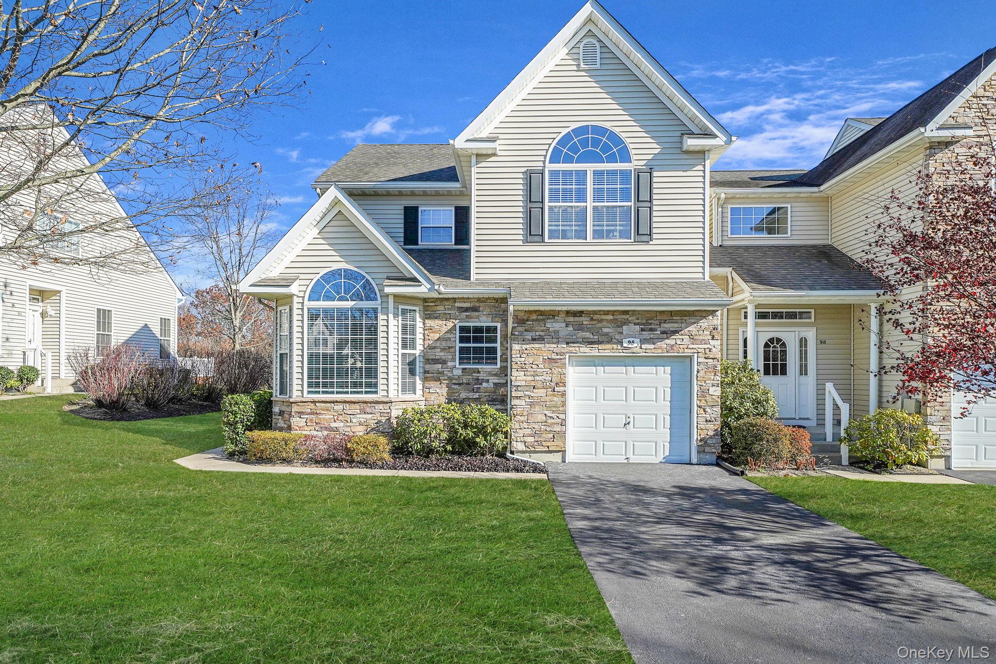 Welcome to 96 Manitou Trail. Gorgeous Ascot End Unit with Rare Primary bedroom & ensuite bathroom on the 1st floor. Step into this charming end unit through a dramatic two-story foyer with soaring cathedral ceilings and expansive windows that bathe the home in natural light. The first floor offers a serene primary suite with en-suite bath, a formal dining room, a welcoming living/family room, and a brand new eat-in kitchen. A convenient laundry room and half bath complete the main level. Upstairs, two generously sized bedrooms share a full bath, alongside a versatile loft space perfect for a home office or second family room. The full basement, with its spacious feel, provides abundant storage or the exciting potential to finish to your taste. Outside, enjoy a private deck overlooking lush surroundings—ideal for summer BBQs, entertaining, or peaceful outdoor dining. With a one-car attached garage, this home blends comfort, functionality, and style in one inviting package.  This beautifully maintained home has undergone extensive updates to ensure modern comfort and style. In May 2024, the entire interior was repainted, including molding, doors, and ceilings, and brand-new hardwood floors were installed upstairs and in the downstairs master suite. The master bath was refreshed in July 2024, followed by custom closets in the master bedroom in August. The kitchen received a full renovation in July 2025, featuring all-new appliances, quartz counters, flooring, and custom lighting. Additional upgrades include a new AC unit (2023), updated hot water heater, fan lamps and custom lighting throughout, and a new washing machine (November 2025), soaring ceilings, upgraded and impressive crown moldings, and CAC. A new roof is scheduled for completion by January 2026, ensuring peace of mind for years to come. Make this your next home. Enjoy Country Pointe living at its best!!!