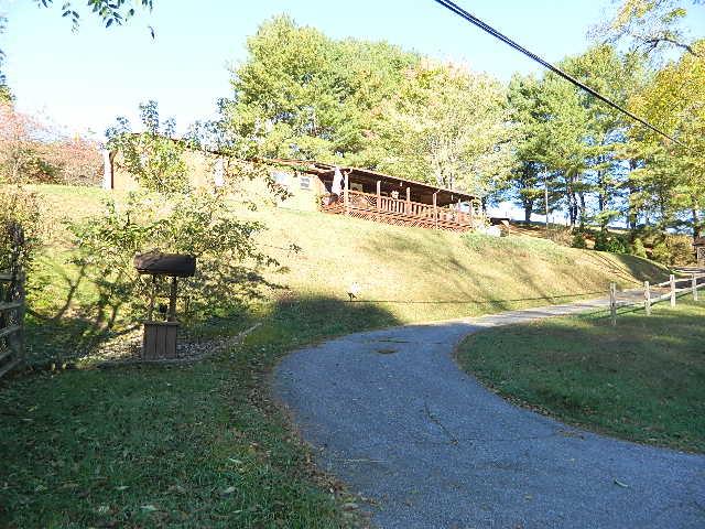 Check out this affordable 3 BR, 1 BA home situated on .72 acre lot out in the county. Located in a beautiful spot in the mountains of Southwest Virginia. A modified mobile home offering a large living area, eat-in kitchen, wrap around covered porch, outbuilding, chicken coop and well house.  Some furnishings will convey. All appliances convey. House is served by a good well. Public water (Thomas Bridge) runs along the road. Check with the Water Corp to see if a new meter would be allowed. Gas for gas heater supplied by Ferrell Gas. Septic pumped in 2023. Outbuilding & garage has electricity. Floor in mudroom has been replaced due to a leaking freezer. Minor repair to south eave needed. Closet floor needs work & one fan light needs repair. Chilhowie school district. Plan a viewing of this affordable home today! Property being sold as is.