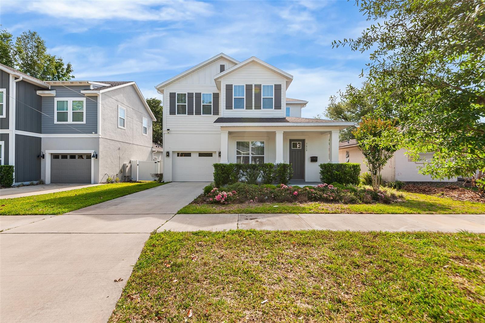 One or more photo(s) has been virtually staged. Welcome Home! This masterfully designed home is in the heart of Orlando's coveted SODO neighborhood, where designer finishes, thoughtful layouts, and resort-caliber outdoor living come together under one roof. Step inside into a generous foyer that immediately sets the tone — luxury Mohawk laminate flooring throughout, soaring ceilings, and curated designer lighting flow throughout the entire first floor. Off the foyer, a glass-door flex room wrapped in dramatic dark hexagonal wallpaper is ideal as a private home office, study, or creative space. A stunning botanical-wallpapered powder room just off the entry adds an unexpected moment of personality that guests will not forget. The heart of the home is the open-concept kitchen, dining, and living area — a space that is nothing short of extraordinary. The chef's kitchen features floor-to-ceiling gray shaker cabinetry with matte black hardware, an oversized black center island with quartz countertops and farmhouse sink, a gas cooktop beneath a commanding black statement range hood, a full suite of Café appliances with brushed bronze accents including a French door refrigerator and built-in double wall oven, under-cabinet lighting, and artisan pendant lighting in gold and glass. The adjacent dining area seats a crowd with ease, and the expansive living room anchors the space with a striking textured gray stone accent wall, designer branch chandelier, and full-view sliding glass doors that blur the line between indoors and out. The first-floor primary suite is a true sanctuary. Tucked privately off the living area, the primary bedroom features a tray ceiling with sleek black ceiling fan, and opens directly into a spa-caliber en-suite bath complete with a dual-sink gray shaker vanity, quartz countertops, an oversized frameless walk-in shower with full subway tile surround, dual rain and handheld shower heads. A custom built-out walk-in closet completes the suite. A dedicated laundry room with Samsung front-load washer and dryer and patterned encaustic tile floor, plus a mudroom bench with hooks and shelving off the garage entry, round out the highly functional first floor. Upstairs, four generously sized bedrooms each feature wide-plank LVP, designer lighting, and ample natural light. Two full bathrooms serve the upper level — one with a dual vanity, subway tile walk-in shower, and glass surround; another with a tub/shower combo — both outfitted with gray shaker cabinetry, quartz countertops, and matte black fixtures throughout. Step outside through the living room sliders to a fully screened outdoor kitchen and lounge with a stainless gas grill, dedicated range hood, mini fridge, dark tile backsplash, ceiling fan, and a sectional seating area — all opening to a fully fenced, private backyard with room to add a pool. Whether you're entertaining a crowd or unwinding after a long day, this outdoor space delivers year-round Florida living at its finest. All of this just minutes from Downtown Orlando, the Hourglass District, the Milk District, SODO's vibrant dining and retail scene, Dr. Phillips Performing Arts Center, and easy access to I-4 — one of the most walkable and lifestyle-rich corridors in all of Central Florida.Homes like this don't come along often. Schedule your private showing today.