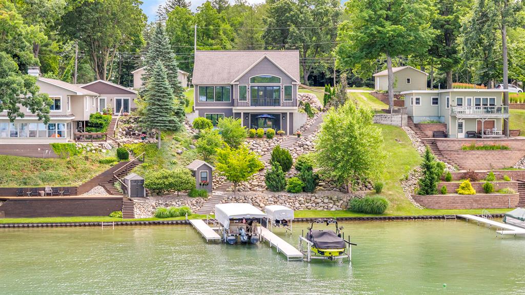 AN EXTRAORDINARY OPPORTUNITY IN THE HEART OF SOUTHERN MICHIGAN, THIS FARWELL LAKE ESTATE COMMANDS ONE OF THE AREA'S MOST COVETED SETTINGS & ARCHITECTURAL EXCELLENCE! Perched on a bluff setting with 79 feet of lake frontage, enjoy panoramic views of this spring-fed, all-sports lake with sunsets that are out-of-this-world! Designed and masterfully crafted, this 3700+ square foot home embodies nautical elegance with seamless indoor-outdoor living. A grand entry opens to expansive interiors that flow effortlessly to lake views as soon as you step inside! An open-concept design tailored around a stunning living room with soaring ceilings, solid hickory hardwood floors, walls of windows & explosive main lake views. The brand new feature wall anchors the living room with a fireplace, custom built-in cabinets & illuminated shelves. Right off the living room, 8 foot siding doors lead to the composite deck where you can view all of the sandbars & fishing holes. The gourmet kitchen offersnumerous top-tier features including custom cabinetry, quartz counters, sprawling center island, stainless steel appliances & personal coffee bar. The owner's retreat is spot on with all the things you dream of-comfort, style, size & luxury! You'll never want to wake up to another view once you've experienced this! Enjoy two custom walk-in closets, dual vanity & the perfect walk-in steam tiled shower with glass enclosure. Beyond the main floor primary bedroom, this home offers a second bedroom, main floor laundry & additional full bath. As you enter the finished walkout lower level, you'll find 9 foot ceilings, heated floors, 3rd bedroom, full bath, spacious living room & lakeside lounge/kitchenette all of your friends can gather around after a day in the sun! The attached 3 car garage has it all; in-floor heat, epoxy floors, hot & cold water plus an easy & convenient separate utility entrance to the lower level. Above the garage is all of the additional space you could ever need. A huge bonus room with another full bathroom-perfect for ove