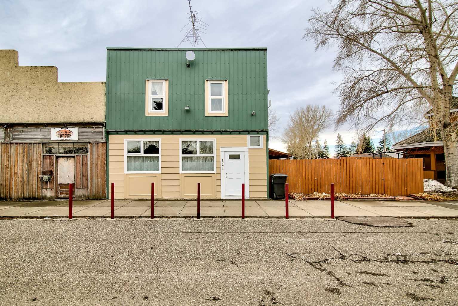 Step into a rare opportunity to own a true piece of local history with the iconic Barons General Store, proudly standing since 1909. This unique mixed-use property seamlessly blends commercial potential with residential comfort, making it an ideal investment for entrepreneurs, business owners, or those seeking a live/work lifestyle.The street-level retail space offers over 2,100 sq ft, featuring a bright and inviting storefront with large updated windows, textured ceilings, and an open layout designed to welcome customers. The additional rear space, thoughtfully divided into two rooms, provides flexibility for storage, workspace, or business expansion. A centrally located washroom, utility area, and ample storage add everyday convenience.Upstairs, the renovated residential suite delivers a warm and comfortable retreat, complete with an open-concept living room and kitchen, three spacious bedrooms, and a full four-piece bathroom—perfect for owner occupancy or additional rental income.Outside, enjoy a private fenced side yard featuring a firepit and covered seating area—an ideal space to relax or entertain. Separate access to the upper level enhances functionality and privacy.Whether you're looking to launch a new venture, expand your portfolio, or embrace small-town living with income potential, this landmark property offers endless possibilities.Don’t miss your chance to own a cornerstone of the community—contact your REALTOR® today to book a showing!