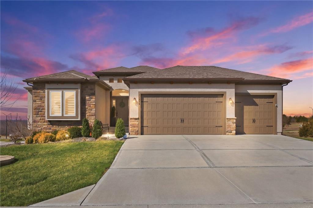 Saying this home has all the bells and whistles is an understatement! SO MANY UPDATES! And MAINTENANCE PROVIDED! No need for a shovel or a lawn mower--this home has that covered! Walk in & immediately admire the 14 foot cathedral ceiling in the great room! Stunning 5 in white oak floors, custom lighting, & plantation shutters adorn the main level living space!  You'll love relaxing in front of the stone fireplace w/custom built shelves on each side! Next, venture into the gourmet kitchen with large, quartz island, gas cooktop & custom cabinets to the ceiling! 9 custom drawers under your cooktop make pot and pan storage so convenient! The walk-in pantry offers exceptional design with shelves/outlets for appliances so those are tucked out of the way! Do you love dining outdoors? You'll enjoy many nights eating dinner on your screened-in composite deck with a mount for your TV! Enjoy sitting out there admiring the huge almost 1/2 acre lot (that you don't mow!). Unwind each night in the primary bedroom with custom barn door to your primary bathroom. Huge walk-in tile shower, granite top vanity with under cabinet lighting and porcelain floors are just some of the features worth mentioning! Laundry room adjacent to your bathroom is convenience at its finest! As you go downstairs, be sure not to miss the large picture windows with custom motorized shades! Lower level welcomes you with a custom built electric fireplace surrounded by shelves. You won't even realize you're in the lower level as it boasts 11 foot ceilings and a 2ND FULL KITCHEN! Kitchen features quartz countertops, under cabinet lighting, custom cabinets, refrigerator, stove, dishwasher, microwave and WALK-IN PANTRY (And YES, you read that right! This is the lower level!) Want to grill? Head on out to your screened in patio with built-in gas grill! Wiring for a hot tub already available on this patio as well! Tons of storage!  Don't miss out on this one!  This immaculate home is the true definition of a GEM!