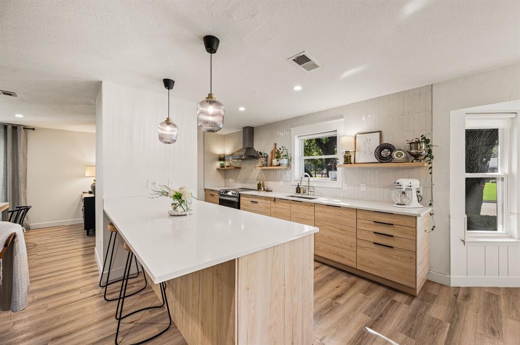 Welcome to this beautifully updated, turnkey 4-bedroom, 2-bathroom single-story home in the desirable Brook Hollow neighborhood of Bedford, located within HEB ISD! The spacious corner lot also features a double gate providing access for RV parking, along with an EV charging pad for added functionality. Conveniently located just minutes from shopping, restaurants, DFW Airport, and major highways, this beautifully refreshed home offers an ideal combination of comfort, convenience, and versatility. Brand-new flooring, fresh interior paint, updated light fixtures, and new appliances create a fresh, move-in-ready feel throughout. The eat-in kitchen is thoughtfully designed with elegant quartz countertops, offering a stylish setting for everyday meals and entertaining. The flexible floor plan includes a spacious guest bedroom, while the oversized primary suite provides a relaxing retreat with plenty of room to unwind. The flex room off the laundry would make for a great office, gym or a guest bedroom. Step outside to enjoy the quaint screened-in porch, perfect for morning coffee or relaxing evenings. The expansive backyard offers ample room to play, garden, or entertain, with a storage shed for added convenience. Don't miss the opportunity to make this charming Bedford home your own!