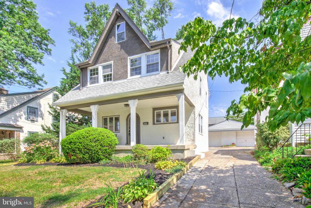 Welcome to this beautifully renovated and spacious 4-bedroom, 3.5-bathroom home with one car garage nestled in a peaceful residential neighborhood in Springfield. With its European-style stucco exterior, steeply pitched roof, and inviting wooden arched front door, this home offers distinctive curb appeal and timeless charm—all just minutes from major highways and the vibrant Greater Philadelphia area. Step inside to discover an open-concept main floor that effortlessly blends classic character with modern updates. Gleaming refinished hardwood floors, an original stone fireplace, and a striking wood staircase create a warm and welcoming atmosphere. The fully updated kitchen features sleek white cabinetry, quartz countertops, a tile backsplash, and stainless steel appliances—perfect for both everyday living and entertaining. A convenient mudroom at the rear of the home provides main floor laundry, a new powder room for added functionality. Upstairs, the elegant second level boasts three generously sized bedrooms and three full bathrooms, including two ensuite suites. The luxurious primary suite includes a sunlit bedroom and a spa-inspired ensuite bath with a walk-in shower, soaking tub, and double vanity. The third floor offers an additional spacious bedroom, with unique ceiling lines that add architectural interest and charm. Additional features include a brand-new, energy-efficient electric heat pump HVAC system for year-round comfort. Don't miss your chance to own this one-of-a-kind home that blends Old World character with modern convenience in one of Springfield's most desirable locations!