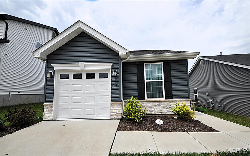 BETTER THAN NEW 1.5 YRS young custom ranch home with 3 bdrms, 2.5 bths & 1900+ sq ft of living space in new Bear Ridge community of House Springs. UPGRADES GALORE! Exterior boasts modern vinyl & stone front w/oversized covered front porch & oversized one car garage. Architectural shingle 30 yr roof. Make your way inside to the entry foyer to be AWED by the open floor plan showcasing vaulted ceilings, divided bedrooms, luxury vinyl plank flooring, custom panel doors & tons of natural light throughout! Main floor living area features great rm w/gas marble fireplace flanked by white mantle. Atrium door to backyard. Kitchen/dining rm combo boasts breakfast bar, quartz counters, custom 42" modern gray cabinets, tile backsplash, oversized single bowl sink & slate stainless steel appliances. Main floor primary bedroom suite w/dbl closets & jack n jill full bath. Second spacious bedroom & 1/2 bth on main. Open staircase down to finished lower level includes sprawling family rm area, full bath with walk in shower & third bedroom w/closet & egress window bringing in TONS of light! RARE OPPORTUNITY to move in to a NEW, CUSTOM built home NOW! MUST SEE!