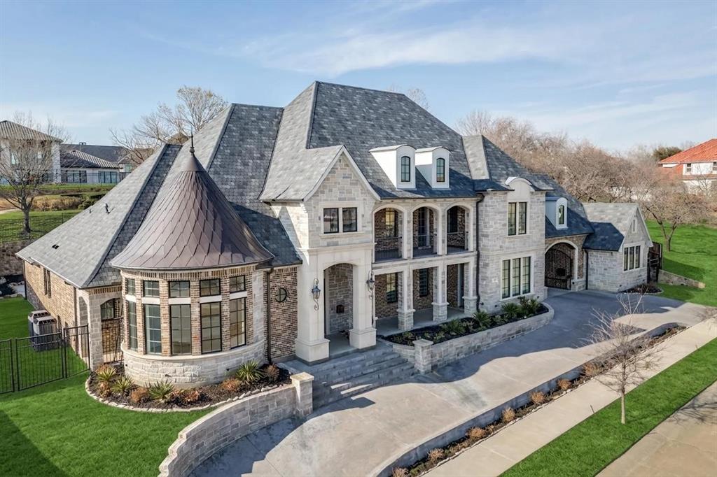 Breathtaking Estate crafted by highly acclaimed Lewis & Earley Custom Homes, completed in 2022 (4 yrs old) and located in prestigious guard-gated Enchanted Hill. This exquisite residence is a masterpiece of thoughtful design and uncompromising luxury, spanning nearly 7,000 sq ft and perfectly balanced for seamless everyday living and grand-scale entertaining.  The home boasts five exceptional bedroom suites—including two primary suites (both downstairs for ultimate convenience) and a dedicated guest suite on the main level, plus two additional suites upstairs—paired with 6.5 baths, a dedicated study, game room, theatre room, expansive 4-car garage, and abundant premium living spaces. No detail overlooked, with architectural elegance and high-end upgrades throughout. The show-stopping chef's kitchen is a culinary dream: premium quartzite countertops, professional Wolf Range (6 burners, grill, pizza option), Sub-Zero refrigerator seamlessly matching the gorgeous custom cabinetry, dual copper sinks, and tailored custom drawers to fit any need. A massive central island pairs with a second social island—ideal for gatherings.  The primary suite is a true luxury retreat, featuring a spa-worthy bath with Bain Ultra hydro-thermo massage tub with air jet system, enormous walk-in shower with Mr. Steam functionality, and an oversized closet rivaling any boutique.  A well-appointed home office near the front entrance complements a versatile second office or flex space with a clever hidden door behind a bookcase, adding even more intrigue to the home. Upstairs, the theatre room flows to an adjacent wet bar (room for full-size fridge) serving the game room, plus a 200+ sq ft balcony with stunning views.  Expansive sliding doors from the family room open to a large, private backyard primed for any gathering.  This rare gem blends timeless craftsmanship, modern sophistication, and resort-like amenities. Don't miss your chance—schedule your private tour today!
