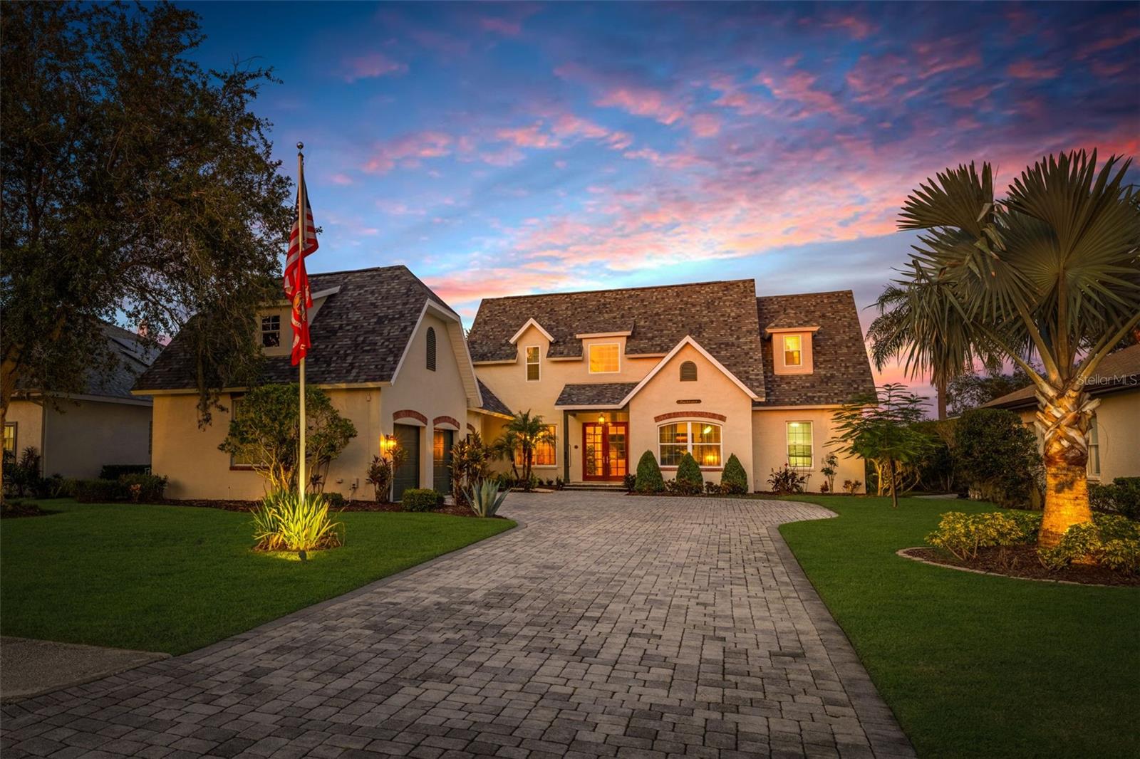 This exceptional chalet-style home in Cory Lake Isle offers luxurious living with stunning, one-of-a-kind features. The pavered driveway leads you to a formal double-door entry, where a peaceful fountain sets the tone for the tranquility within. This custom built home greets you with a spacious great room, soaring two-story ceilings and expansive transom windows, bringing the outdoors in and framing the home’s deep-water views. The sparkling pool and spa are heated for 12 months of enjoyment. Lake views stretch in both directions with conservation beyond, feels like you are surrounded by nature. Inside, mahogany wood flooring  and crown molding flows seamlessly throughout. The gas fireplace is the perfect spot for holiday decorations and cozy evenings spent looking over the stunning lake views. New accordion-style sliders open to the vast lanai, which features multiple areas for enjoying the Florida sunshine. From casual meals to the gazebo, this outdoor space is designed for seamless indoor-outdoor living. Prefer dining al fresco? The dining area and summer kitchen are perfect for meals surrounded by natural beauty. The stately elm tree stands guard over this beautiful home. Formal living and dining rooms are in the front of the home with the gourmet kitchen nearby. Designer sage green cabinetry with multiple glass doors, gas stove, top of the line appliances, large island with vegetable sink, cookbook shelves, decorative bins and exotic marble countertops make this a truly special kitchen. Cozy breakfast nook looks over the lanai and pool area. The first-floor primary bedroom offers French doors leading to the lanai, while the ensuite bathroom is a true retreat, complete with double sinks, a walk-in shower, a jetted tub, and a built-in vanity. On the opposite side of the home, two generously sized guest bedrooms with oversized closets share an additional bathroom. Upstairs is an oversized second primary bedroom and ensuite bathroom. French doors open to a private balcony overlooking the lake, the perfect bedroom for the princess in the family. Across the catwalk there is another large bedroom AND additional versatile space which could be used as a bonus room, nursery, office, or extra bedroom. Large laundry with cabinets and shelves. The extended three-car garage is both wider and deeper than a typical garage and provides ample storage space, ensuring that everything has a place in this thoughtfully designed home. This light and bright home is perfect for sun-loving homeowners. It combines exceptional craftsmanship with the beauty of Florida living, offering the opportunity to enjoy the Florida sunshine and the lake views at every turn. Cory Lake Isle Beach Club has a massive resort-style pool and slide, boat dock, workout facilities, gathering room and pool cabana, tennis and basketball courts, roller hockey and sports fields as well as a 3-mile perimeter around Cory Lake, for after dinner walks. ROOF IS TWO YEARS OLD. Front windows replaced and exterior has been recently painted. This gated community has 24/7 manned security, two gates and easy access to I75, I275, downtown Tampa, Tampa International Airport, Moffitt Cancer, University of South Florida, Haley VA Hospital. Three hospitals within a few miles and innumerable restaurants, entertainment, and malls. The Cory Lake lifestyle is unlike any other community and is frequently called Paradise in New Tampa. If you want to love where you live, make sure this home is on your list.