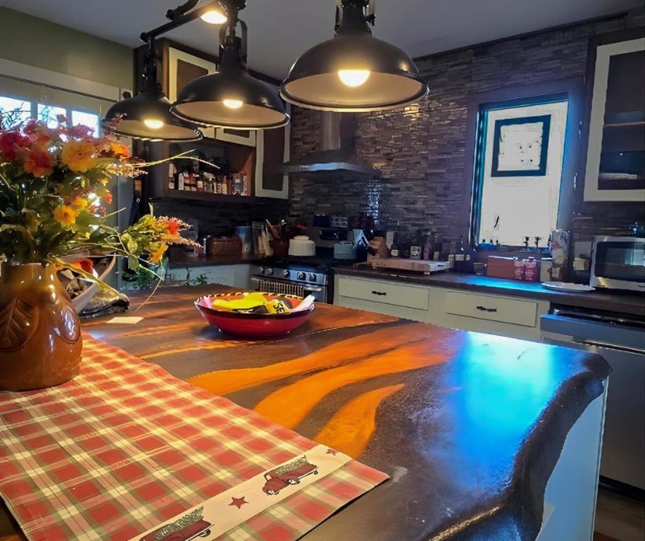 Situated on 4.19 private acres, this six year old custom log cabin exterior, offers quality construction, efficient living, and true privacy. With annual taxes around $400 and minimal utilities thanks to well and septic systems, this property was built for low maintenance, long term simplicity. The exterior was milled from wood harvested directly from the land, giving the home authentic character and a level of craftsmanship that is difficult to replicate. Inside, the layout is thoughtfully designed with true main level living. The kitchen opens directly into the living room, creating a functional, comfortable space that feels connected without wasting square footage. The home features one bedroom and one full bath on the main level, plus a spacious loft upstairs with multiple beds that easily accommodates guests or additional family members. Custom woodworking details that add warmth throughout the interior. The property includes a circle drive, detached two car garage, and established fruit trees across the acreage. Offered FULLY furnished, this is a turnkey opportunity whether you are looking for a primary residence, weekend retreat, or investment property. If you are looking for space, privacy, and a well built home off the beaten path, this property delivers.