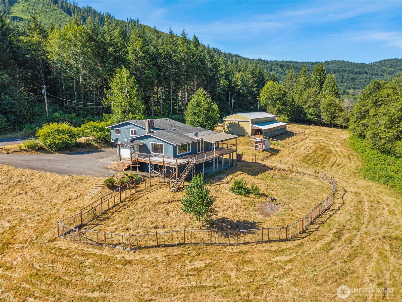 Sweat Equity Opportunity!  Peaceful mountain feel setting surrounds this large home and 15 acres.  Spacious home with newly painted exterior and newer roof.  Interior needs remodeling but mostly cosmetic.  Large rooms.  Huge deck that overlooks rolling pasture and timber.  Peak-a-boo Mt Rainier view.  Huge outbuilding that will house commercial truck or RV plus lean-to /barn for animals. Enjoy the views of rolling pastures and garden areas.  Paved circular drive.  Come restore this to its former charm. Seller financing available to assist in the updating.  Don't hesitate as it will slip away.