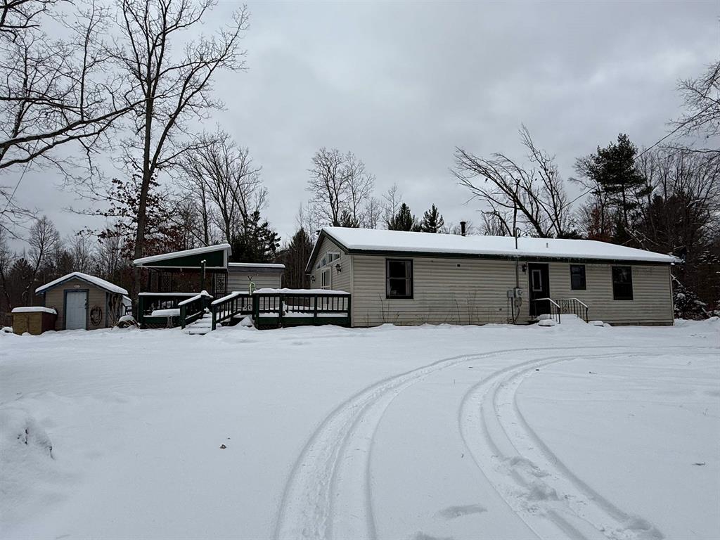 No trespassing on property without scheduled appointment. SHOW BY APPOINTMENT ONLY. Set on a scenic 21.5 acres, this 3-bedroom, 2-bath home offers space, privacy, and endless opportunities to enjoy the outdoors. Inside, youll find an open living room warmed by a cozy wood-burning fireplace that flows into the kitchen and dining area-perfect for everyday living or gathering with family and friends. Outside is where this property really shines. A large garage and multiple sheds provide plenty of storage for equipment and toys, while the outdoor wood burner adds efficiency and comfort. Enjoy the views from the deck, explore the established trails, or settle into the heated deer blind right on the property. Much of the land is already fenced, making it ideal for recreation. Best of all, the end of the road opens directly into thousands of acres of Huron National Forest, with easy access to snowmobile and ORV trails. Whether youre looking for a peaceful retreat, a recreational base camp, or a place to enjoy the outdoors year-round, this property checks all the boxes.