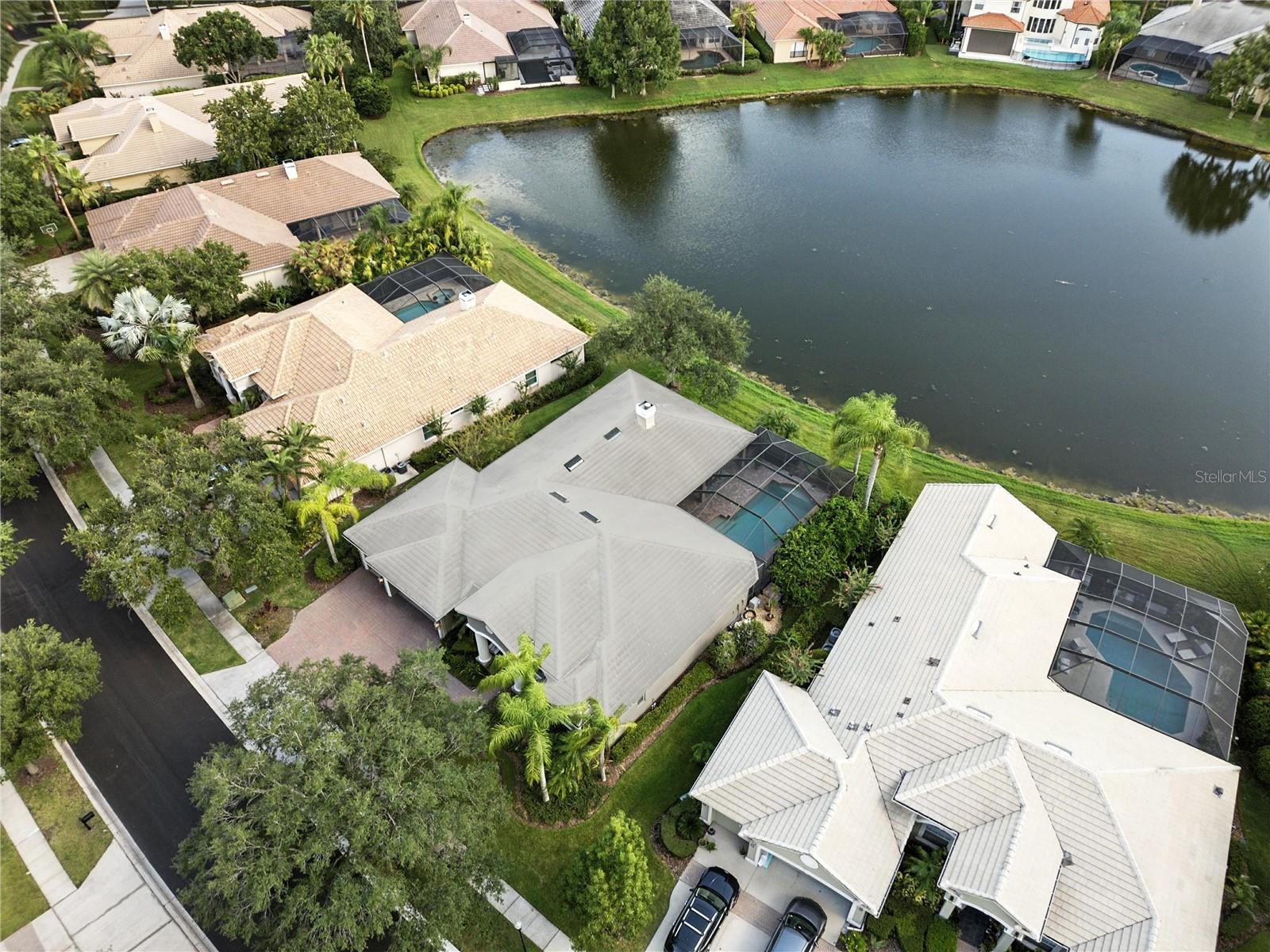 Exquisite Tampa Palms Estate in Gated Lancaster
A residence of rare sophistication, this 4BR + Office, 3.5BA, 3CG executive pool home is perfectly sited on a tranquil pond in a quiet cul-de-sac. Every inch has been artfully renovated, showcasing soaring ceilings, rich hardwood floors, custom millwork, and captivating water views from nearly every room.The showpiece kitchen features an expansive leathered granite island, bespoke cabinetry with crown detail, gas cooktop, double ovens, twin wine chillers, and designer lighting. Spa-inspired baths are adorned with granite, elegant fixtures, and refined finishes. The split plan offers two guest rooms with shared bath, a private ensuite, and an indulgent master retreat with sitting area, custom closet, and a luxe bath with garden tub and walk-in shower. Outdoors, a pavered lanai frames a sparkling pool, perfect for alfresco entertaining. Recent upgrades include landscape lighting, AC (2021), water heater (2022), pool motor (2022), water softener, and a reimagined laundry.Residents enjoy Club Tampa Palms with pools, fitness center, spa, sauna, and more. Close to shopping, Moffitt, VA Medical Center, USF, gourmet restaurants, and easy commute to downtown via I-75 or I-275. Don’t miss viewing this exceptional, well maintained home!
