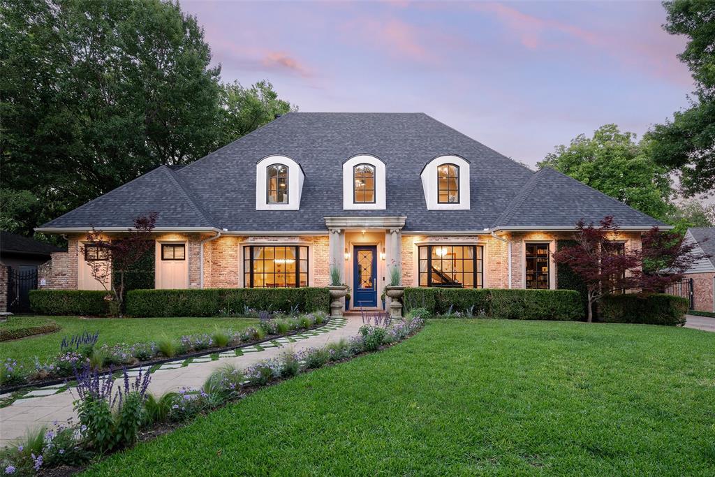 Situated near area’s top private schools, this Strait Lane offering sits on Dallas’ most iconic street. Coveted creek lot provides optimal privacy with expansive indoor-outdoor living space for the discerning homeowner. Modern guest house & outdoor spaces offer rare, secluded lot with multi-sport court, outdoor kitchen, pool & deck areas. Resort-like family living includes water features & fire pits. Soaring 10-ft ceilings accentuate light-filled casement windows & French doors, combining sophistication & warmth to open spaces with elegant formals including dining, living room, music room, & office with built-in wine storage. Hand-forged Brazilian hardwoods throughout. Skylit 2-story foyer opens to spacious living area. Premium kitchen with granite & marble, state-of-the-art appliances, custom cabinetry. Cantilevered deck above creek, canopied by trees. Designer Swarovski, Currey & Co, Murano Sputnik lighting, bespoke Joseph Giles, Sherle Wagner, Versace hardware. Waterstone plumbing integrates beauty & function into custom millwork. Primary suite down with sitting room-office. Spa bath with Brizo plumbing fixtures, hand-carved imported Italian marble, free-standing soaker tub, curated lighting & mirrors. Four additional bedrooms & two baths flank spacious upstairs game room with built-ins & arched nooks. Backyard oasis boasts pool & waterfall. Ipe Brazilian Hardwood deck, with fully equipped outdoor kitchen, bar, & alfresco dining for 12, extends to spacious pool-guest house with 20-foot accordion glass doors, sleepover loft, indoor kitchen, bath, steam room & sauna. Indoor-outdoor living space with pool-ping pong table opens to bifold doors leading to private sports training court & an unobstructed views of tree-lined creek. Integrated surround sound & floating balcony extend the deck over the creek. Meticulous attention to detail blends timeless style with clean-lined sophistication, offering unparalleled privacy in a coveted Preston Hollow neighborhood.