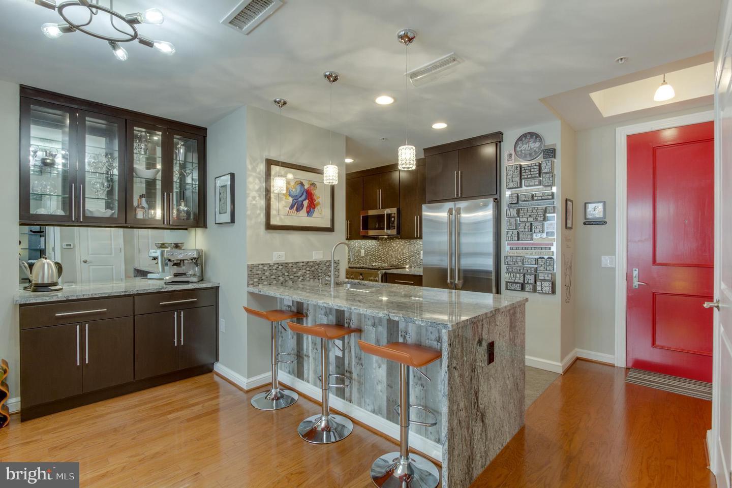 Experience luxury living at Midtown at Reston Town Center in this beautifully renovated 16th-floor residence featuring soaring 10-foot ceilings, hardwood floors, and an open-concept floor plan designed for both everyday living and entertaining. The gourmet kitchen showcases granite countertops, a breakfast bar, and GE Monogram stainless steel appliances. The spacious layout offers two large bedroom suites, each with its own updated luxury bath, custom closets, and high-end finishes throughout. An elegant fireplace, custom dry bar, and sunroom with built-in buffet add style and functionality rarely found in condominium living. The unit includes a full sized washer and dryer and two reserved garage parking spaces. Residents enjoy Midtown's truly outstanding, premier amenities and an unbeatable location just steps from Reston Town Center's restaurants, shops, entertainment, parks, and Metro access, with convenient proximity to the W&OD Trail and Dulles International Airport.