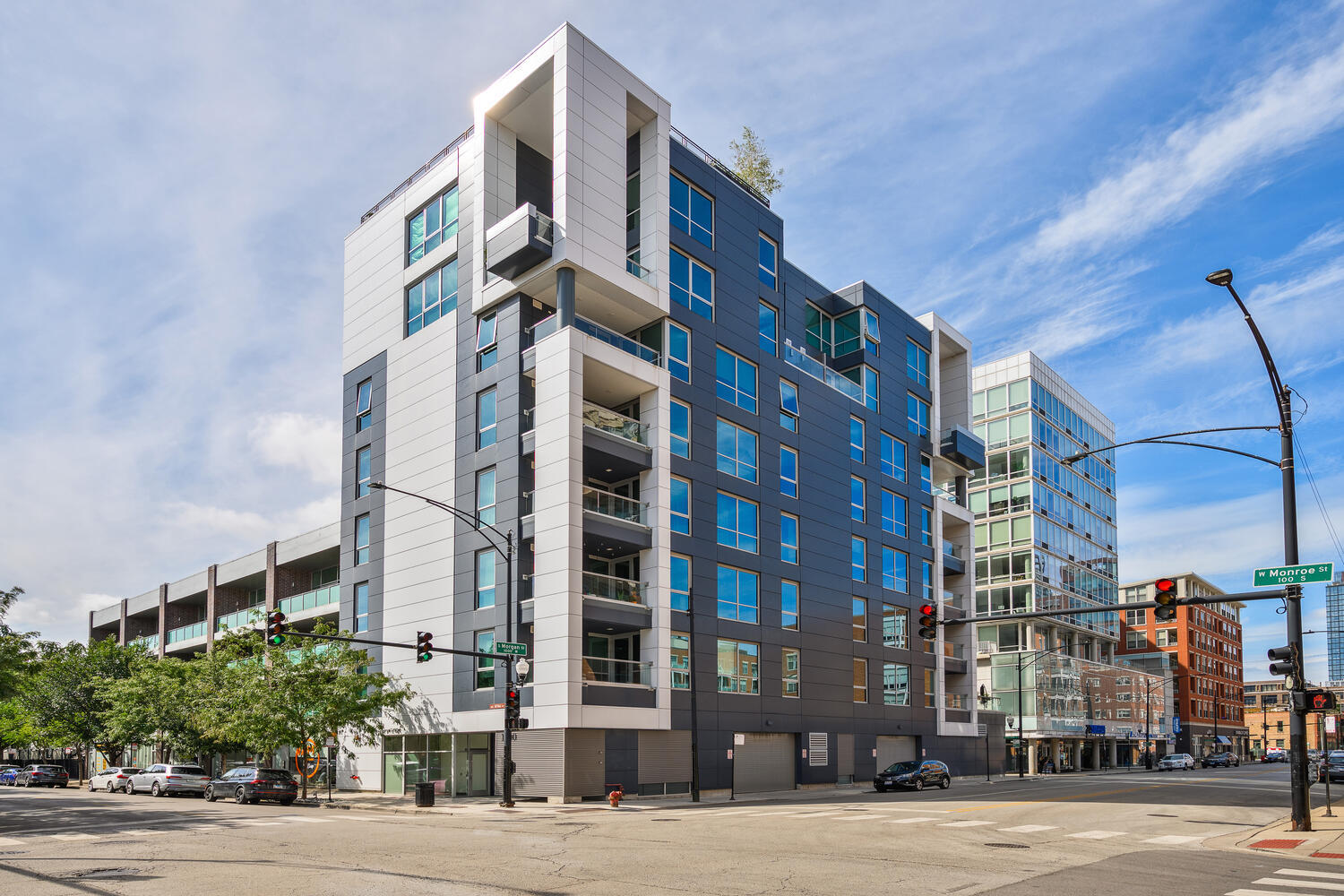 Tastefully designed with clean architectural lines and sophisticated finishes, this 2,036-square-foot, three-bedroom, two-and-a-half-bath residence offers an exceptional lifestyle in the heart of the West Loop within an intimate boutique elevator building with only two homes per floor. Expansive floor-to-ceiling windows and soaring ceilings fill the open-concept layout with natural light, accentuating the seamless transition between living and entertaining spaces. Anchoring the home, the chef's kitchen showcases custom cabinetry, Wolf, Sub-Zero, and Bosch appliances, a generous island with breakfast bar, and a striking backlit, glass-encased 360-bottle temperature-controlled wine cellar. Just off the living and dining area, an east-facing balcony with gas hook-up provides an inviting setting for morning coffee or evening grilling. The serene primary suite features a spacious bedroom, a fully customized walk-in closet with an additional wall of shoe storage, and a spa-caliber bath adorned with Italian porcelain, dual sinks, a separate vanity, radiant heated floors, premium fixtures by Kohler, Grohe, and Duravit, and a large walk-in shower with a custom glass enclosure. A thoughtfully designed split floor plan ensures privacy, offering two additional bedrooms with walk-in closets, a stylish full bath, and a powder room, all elevated by refined finishes throughout. Every bathroom is enhanced with radiant heated floors, while automated window treatments throughout the home add both comfort and convenience. Completing this exceptional offering is one heated garage parking space with lift capability for a second car. Perfectly situated near Mary Bartelme Park-with its playground, dog park, community events, and seasonal farmer's market-and moments from Randolph Street, Fulton Market, the Loop, and public transportation, this remarkable residence blends modern sophistication, everyday comfort, and the vibrant energy of West Loop living.