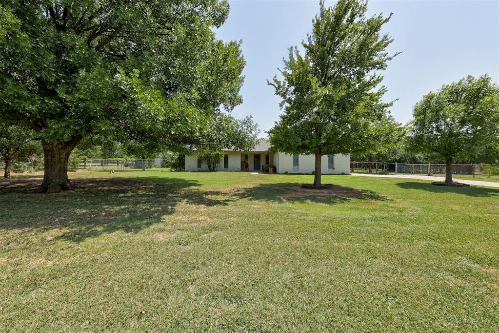 Welcome to 1108 Mesa Trail; a beautifully updated home that combines modern upgrades with the privacy and space of country living! Situated on a picturesque 2.48 acre property surrounded by mature trees, this stunning estate will draw you in from the moment you set foot on the property.Upon entry, you’ll be greeted by an extensively remodeled interior complete with a redesigned chef's kitchen featuring butcher block countertops and modern finishes. A spacious pantry provides abundant storage for everyday living. Bathrooms are no exception to this charming country home's elegance, featuring granite-topped vanities and stunning tile detail for luxurious living! Major systems have already been replaced, giving buyers peace of mind: New overhead HVAC system and ductwork (2025), New water heater (2025), New electrical panel (2026), and Class 4 impact-resistant roof (2020), which may qualify for insurance discounts!Outside, enjoy an outdoor living space built for entertaining. The custom pergola and outdoor kitchen create the perfect place for family gatherings, cookouts, or relaxing evenings.One of the property’s standout features is the impressive 20’ by 40’ shop with electricity—ideal for woodworking, hobbies, or vehicle storage.Nature lovers and gardeners will appreciate the established landscape, including: More than 15 mature pecan trees, two producing fig bushes, established garden area, well-water for irrigation, and plenty of room to expand or simply enjoy the peaceful setting! Whether you’re looking for space to entertain, room for hobbies, or simply a home where the major expenses have already been taken care of, 1108 Mesa Trail offers a rare combination of modern updates, outdoor amenities, and long-term value - all of this in the sought-after Edmond North school district and with easy access to shops, restaurants, groceries and more -- schedule your private tour today!
