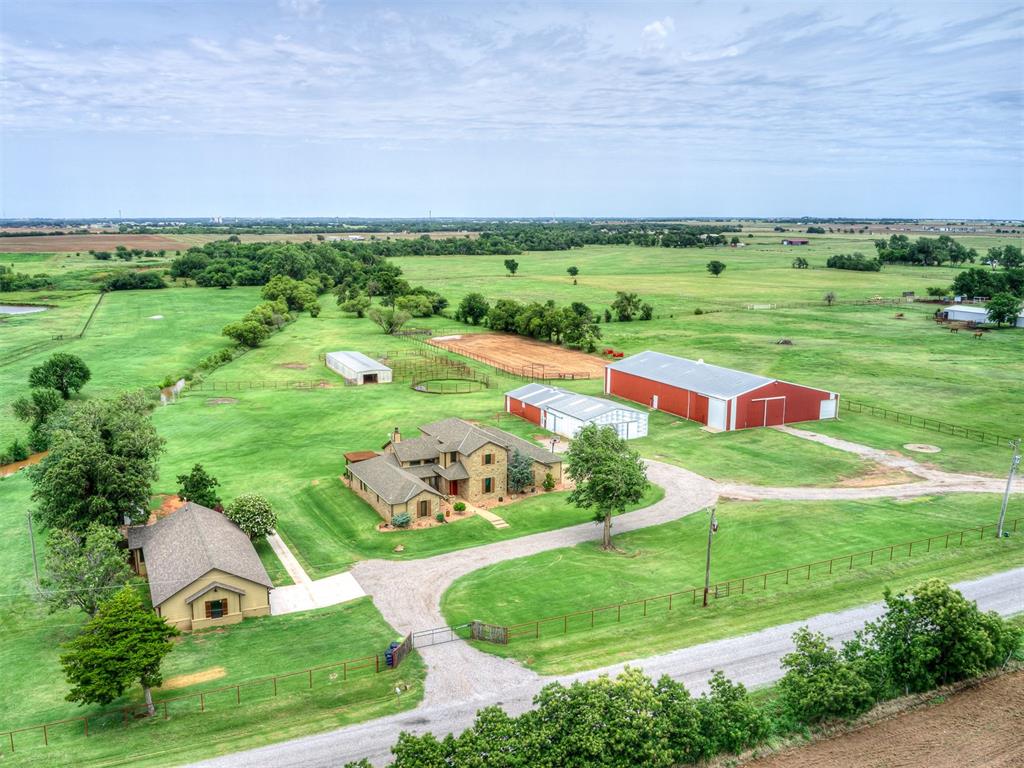NOTE:  Primary house is NOT in flood zone, and does not require flood insurance.  Ask your Realtor to see info in supplements.  Exceptional equestrian property, located in sought after Banner School District, offering a well-maintained home on 20 acres, with another 20 available.  Includes a guest/mother in law/ or caretakers cottage, extensive horse facilities on beautifully maintained acreage with creek, trees, pasture and ponds.  Electric gate at property entrance.  The main home features spray foam insulation, a newly constructed kitchen island, two recently replaced water heaters (including one tankless unit), 2 bedrooms and 2.5 baths on the main level, plus 2 additional bedrooms, a Jack-and-Jill bath, and a second living area upstairs. All carpeted areas have new carpet.The guest house has been completely renovated on the exterior with new siding, a new roof, and an added garage. It offers 2 bedrooms, 1 bath, a mud/utility room w/ access to under house.Designed for serious horse/livestock enthusiasts, the property includes a 7,801 SF (72' x 108.35') galvanized metal enclosed indoor riding arena with electricity, dirt footing, and multiple horse stalls; a 1,296 SF (36' x 36') galvanized metal workshop with an attached 1,755 SF (36' x 48.75') galvanized metal barn featuring electricity, dirt flooring, tack room, and multiple horse stalls; and an additional 2,160 SF (24' x 90') galvanized metal barn with electricity, dirt flooring, and multiple horse stalls.The acreage is fully fenced with a combination of pipe and cable fencing and includes a creek, pond, beautiful views, abundant wildlife, and horse training facilities. This meticulously maintained property offers a rare combination of quality improvements, functional equestrian amenities, and scenic surroundings.