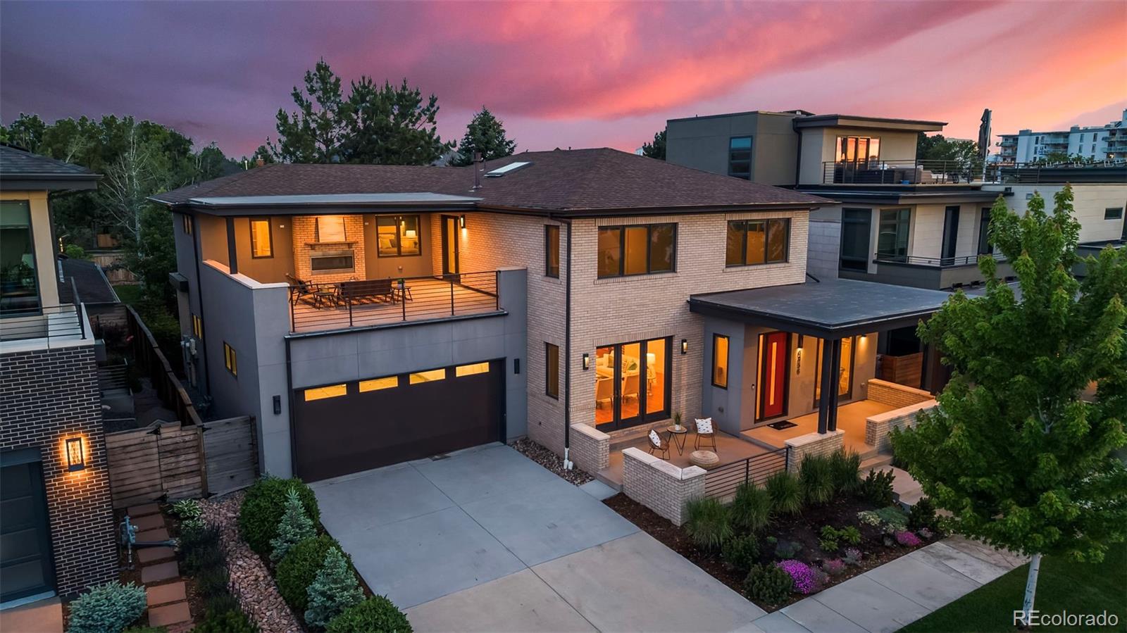 Welcome to this exceptional modern residence in Denver’s highly sought-after Boulevard One at Lowry neighborhood. Perfectly positioned across from a community park, this home enjoys protected open views, abundant natural light, and a seamless blend of luxury, comfort, and energy efficiency. The main level showcases soaring ceilings, wide-plank hardwood floors, and an open-concept design ideal for both everyday living and entertaining. The chef’s kitchen features premium Thermador appliances, custom cabinetry, quartz countertops, and an oversized island that anchors the living and dining spaces. Walls of windows create a bright, inviting atmosphere throughout. A standout feature is the covered second-floor terrace overlooking the park. Complete with a gas fireplace, television and audio connections, wet bar, and wine refrigerator, this outdoor living space is perfect for year-round entertaining or relaxing Colorado evenings. The spacious primary suite offers a spa-inspired retreat with a steam shower, soaking tub, dual vanities, and a generous walk-in closet. Multiple additional bedrooms and bathrooms provide flexibility for family, guests, home offices, or multigenerational living. The finished lower level expands the home’s versatility with a large recreation and media area, additional bedroom and bath, and ample space for fitness, gaming, or entertaining. Designed with sustainability in mind, the home includes owned solar panels, a HERS 40 energy rating, dual high-efficiency Carrier furnaces, central air conditioning, and dual Navien smart on-demand water heaters. Residents enjoy easy access to Lowry Town Center, Crestmoor Park, Boulevard One retail and dining, Cherry Creek, Downtown Denver, and Anschutz Medical Campus. Combining modern architecture, exceptional efficiency, and an unbeatable location, this is a rare opportunity to own one of Boulevard One’s premier residences.