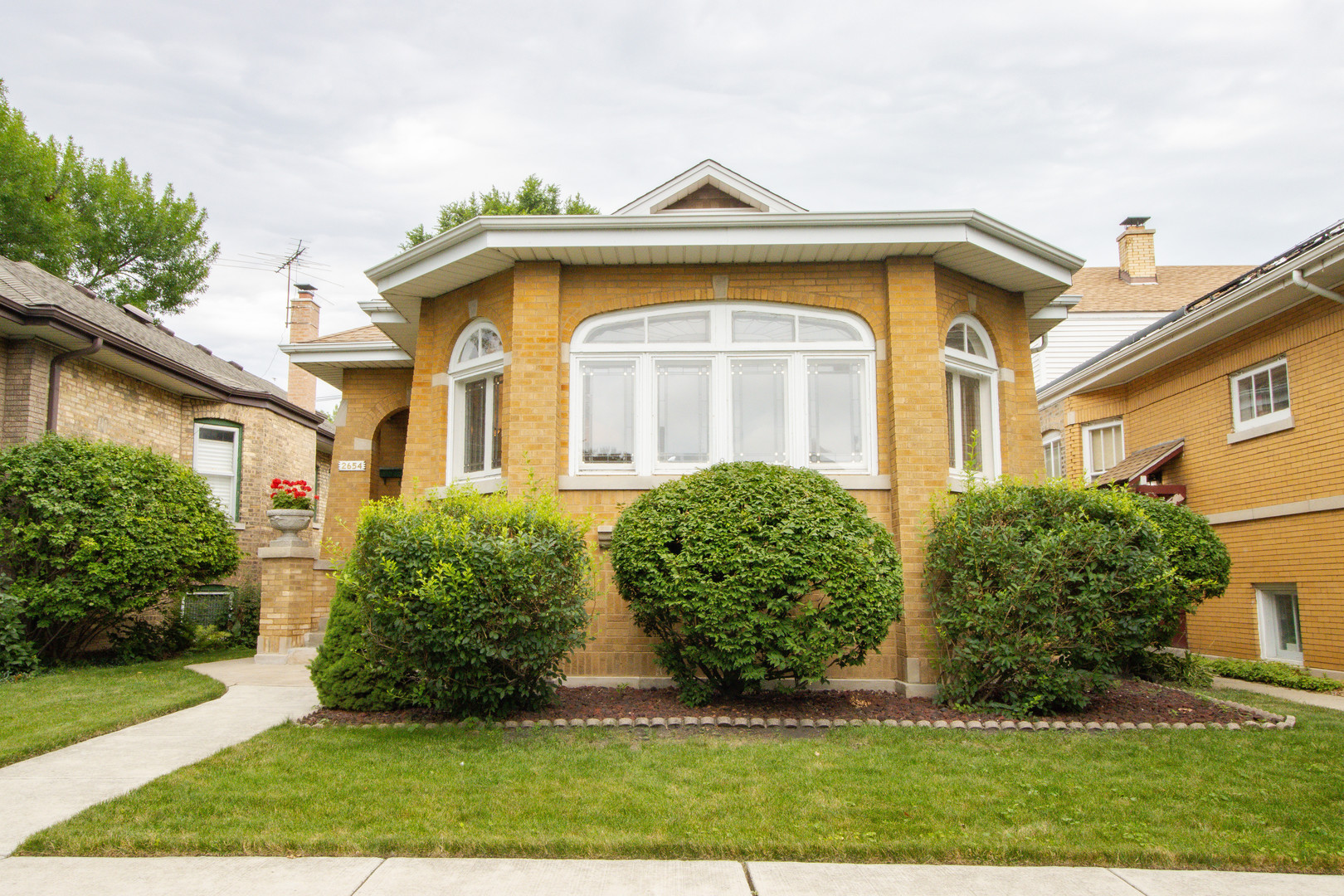 4BR/2BA Updated Brick Bungalow on 36-Foot Lot Where Modern Comfort Meets Classic Style.    Set on a rare 36-foot-wide lot in West Rogers Park, this fully updated brick Bungalow offers a perfect blend of timeless character and modern convenience across three spacious levels.    The bright and airy main floor features refinished hardwood floors, updated lighting, and updated windows throughout. A welcoming foyer leads to the formal living and dining rooms with original leaded glass accents, while the brand-new eat-in kitchen boasts ample cabinetry, updated counters, brand new appliances and a functional layout.    This main level also includes two bedrooms, a full bath, a sunny den/home office, mudroom, and elegant architectural details. Upstairs, you'll find two additional bedrooms with all-new carpeting, dormered ceilings, and great closet space.    The full walk-out basement offers an expansive recreation room, two oversized storage rooms, a newly remodeled full bath, and a new hot water heater and sump pump for peace of mind. All carpet throughout the home is brand new.    Outside, enjoy a beautifully landscaped backyard, concrete patio, and 2-car detached garage-all just minutes from parks, schools, shops, and public transportation.