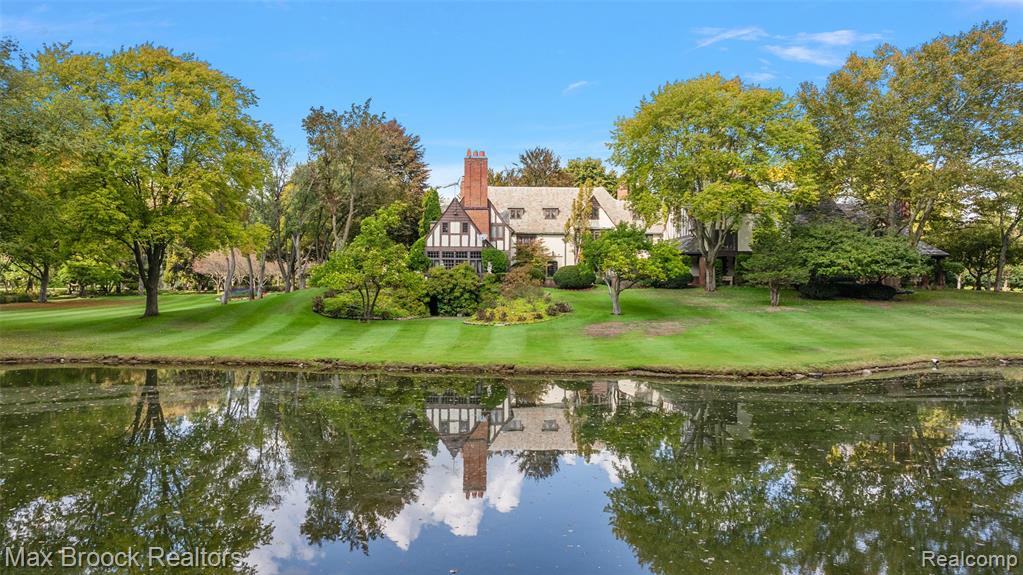 There are homes that impress, and then there are estates that transcend time. Inspired by the regal architecture of Europe’s grandest castles, this extraordinary Bloomfield Hills estate offers a rare fusion of history, artistry, and unmatched privacy on over eight breathtaking acres. This one-of-a-kind residence offers unrivaled seclusion, elegance, and architectural splendor. Surrounded by mature trees, manicured gardens, and expansive green lawns, the property evokes the tranquility of a private sanctuary. From the moment you arrive, the home’s old-world craftsmanship is on full display, featuring intricate millwork, hand-carved wood details, ornate plaster ceilings, and rich finishes that reflect a bygone era of artistry and refinement. A grand foyer welcomes you into expansive formal spaces designed for elegant entertaining, including a stately library, formal dining and living rooms, and a magnificent ballroom reminiscent of classic European estates. Among the estate’s most captivating features is the bar area, adorned with original tile imported from Napoleon Bonaparte’s carriage house in France, an extraordinary historical detail rarely found in private homes. Outdoors, the estate continues to impress. Rolling lawns, wooded enclaves, and a sparkling swimming pool provide an exceptional backdrop for outdoor living. A private tennis court and guest house is also located on the grounds. This is more than just a home. It's a legacy property of rare distinction. With timeless beauty, ultimate privacy, and proximity to the best of Bloomfield Hills, this estate offers a lifestyle reserved for the truly discerning.