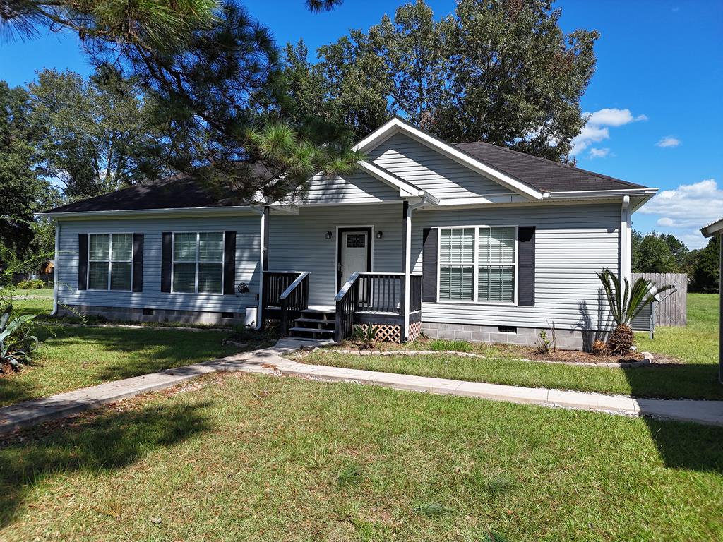 3 Bedroom 2 Bath home on 1+ acre. Great property close to town. This home has lots of potential. Large living room and a split bedroom plan. Sit on the covered back porch looking out onto the large lot. Property has two detached garages.