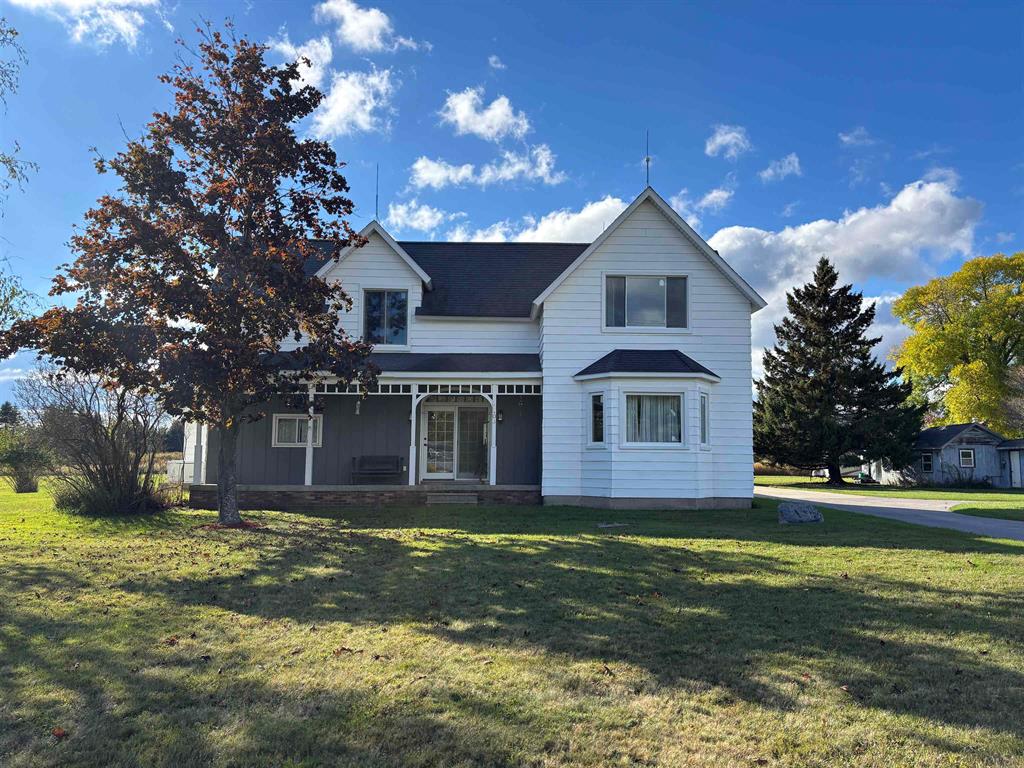 This charming 4-bedroom, 2.5-bathroom farmhouse sits on 2.04 acres and offers the perfect blend of space, character, and country comfort. Located on a paved road minutes from the renowned Red Hawk Golf Course and only 7 miles from downtown East Tawas, this property offers both tranquility and convenience. Inside, the spacious family room features high ceilings, a gas fireplace (easily convertible to wood-burning), and a new sliding glass door that fills the area with natural light. Several windows have recently been updated including in the master bedroom. The kitchen boasts warm Haas cabinets, a walk-in pantry offering plenty of storage and functionality for everyday living. Just off the kitchen, the dining room provides a welcoming space for family meals and gatherings, accented by elegant glass French doors that open onto the front porch. The master suite includes a private bathroom with a hot tub for relaxing after long days. Upstairs, youll find two additional bedrooms, a half bathroom, and a large bonus area, perfect for a kids playroom, craft space, or home office. This property also offers a spacious three car detached garage with abundant storage for vehicles, tools, and other equipment. Step outside and enjoy the peace and beauty of Wilber Townships "Sunrise Side". The property is near scenic hiking and biking trails, Tawas Point State Park, and all the amenities of East Tawas and Tawas City. Not to mention all the state land in the surrounding area for hunting and skiing. Whether you are looking for a serene retirement home or a northern Michigan getaway, homes like this dont come along often! This is a rare opportunity in sought after and desirable Wilber township, don't miss this one! The circle drive is partially located off the property this may not and should not be assumed to be available for use by the new owner.